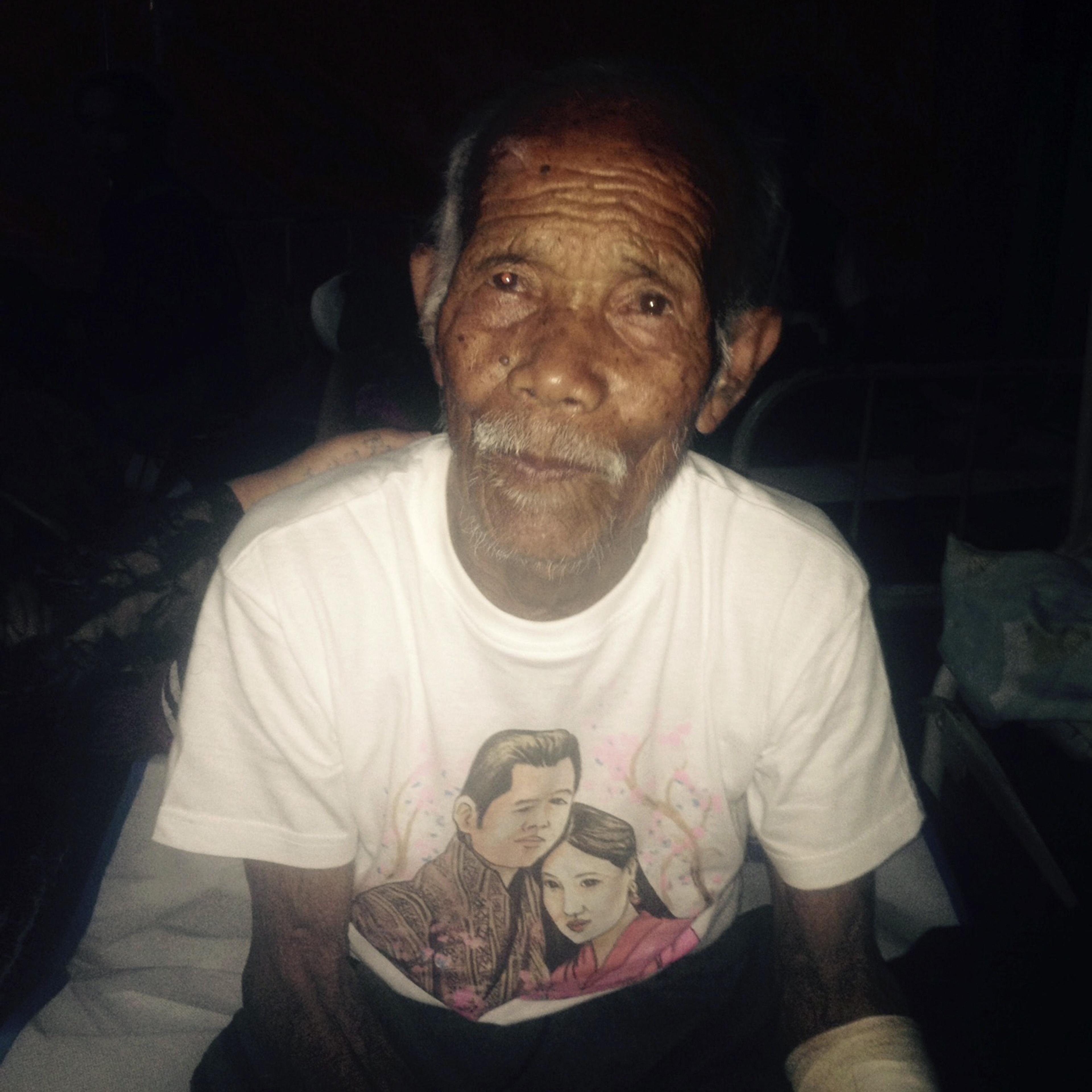 Funchu Tamang, 101, sits on a bed in a hospital in Nuwakot district northwest of Kathmandu where he was taken after being rescued from his collapsed home