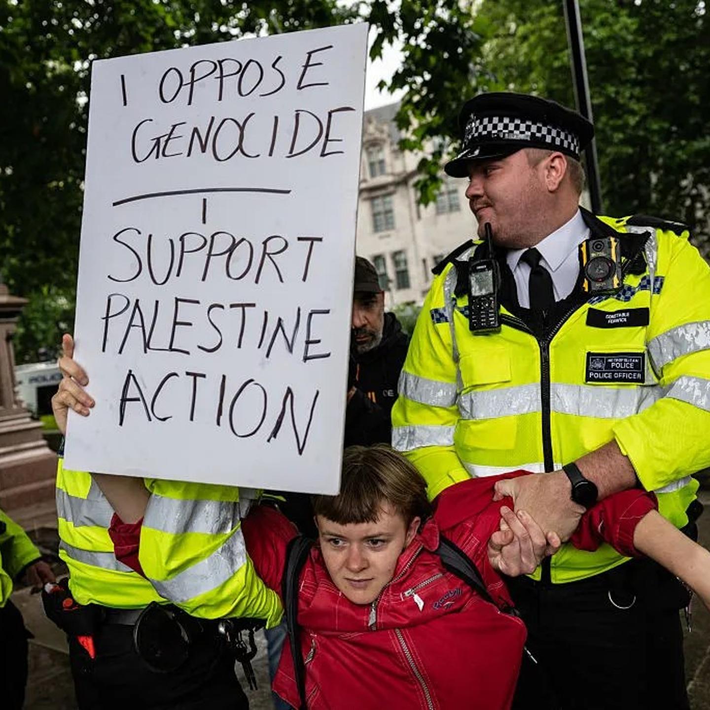 British police detain a protester for holding a sign that reads "I oppose genocide. I support Palestine Action," in London on July 5, 2025.