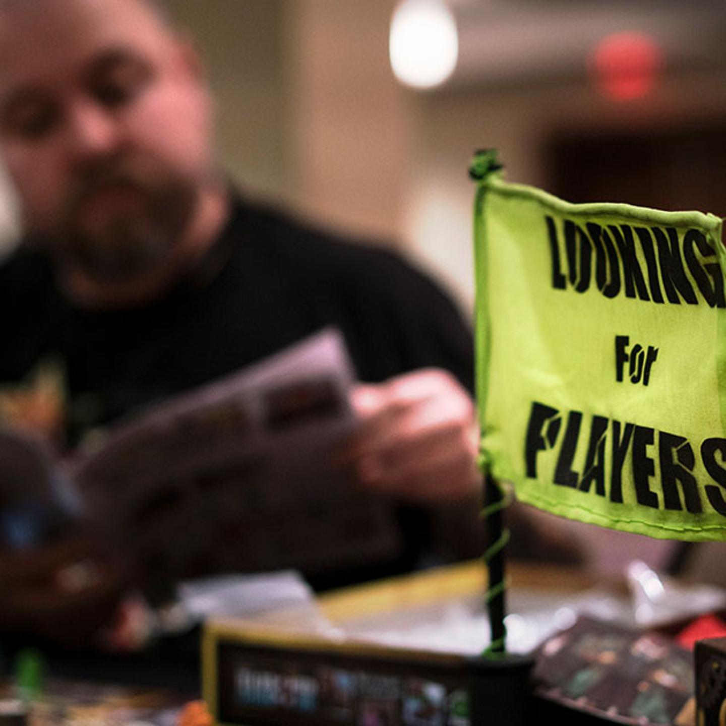 A man looks through instructions while playing a board game during the Cleveland Concoction March 11, 2016 in Cleveland, Ohio.
