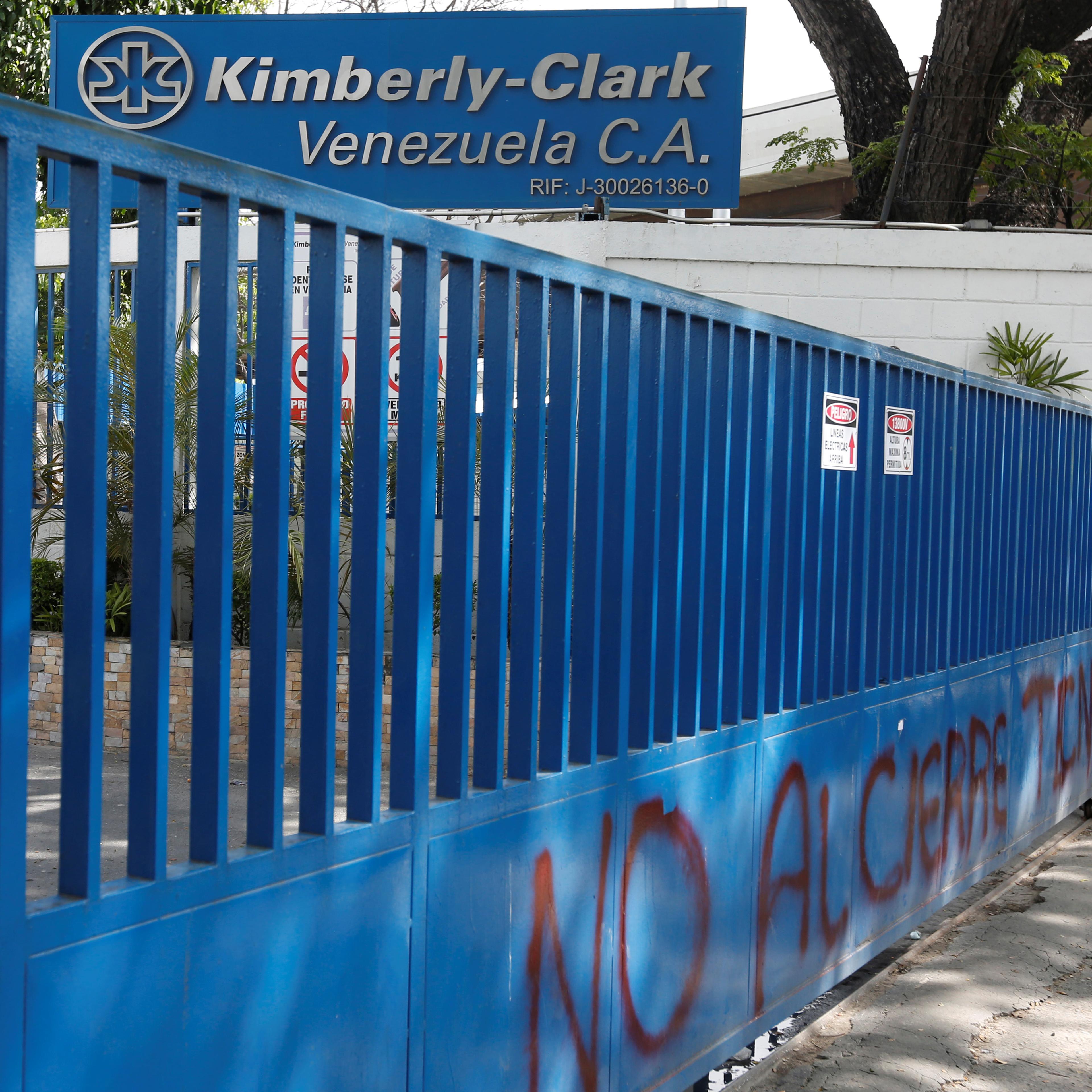 Employees stand outside Kimberly-Clark in Maracay