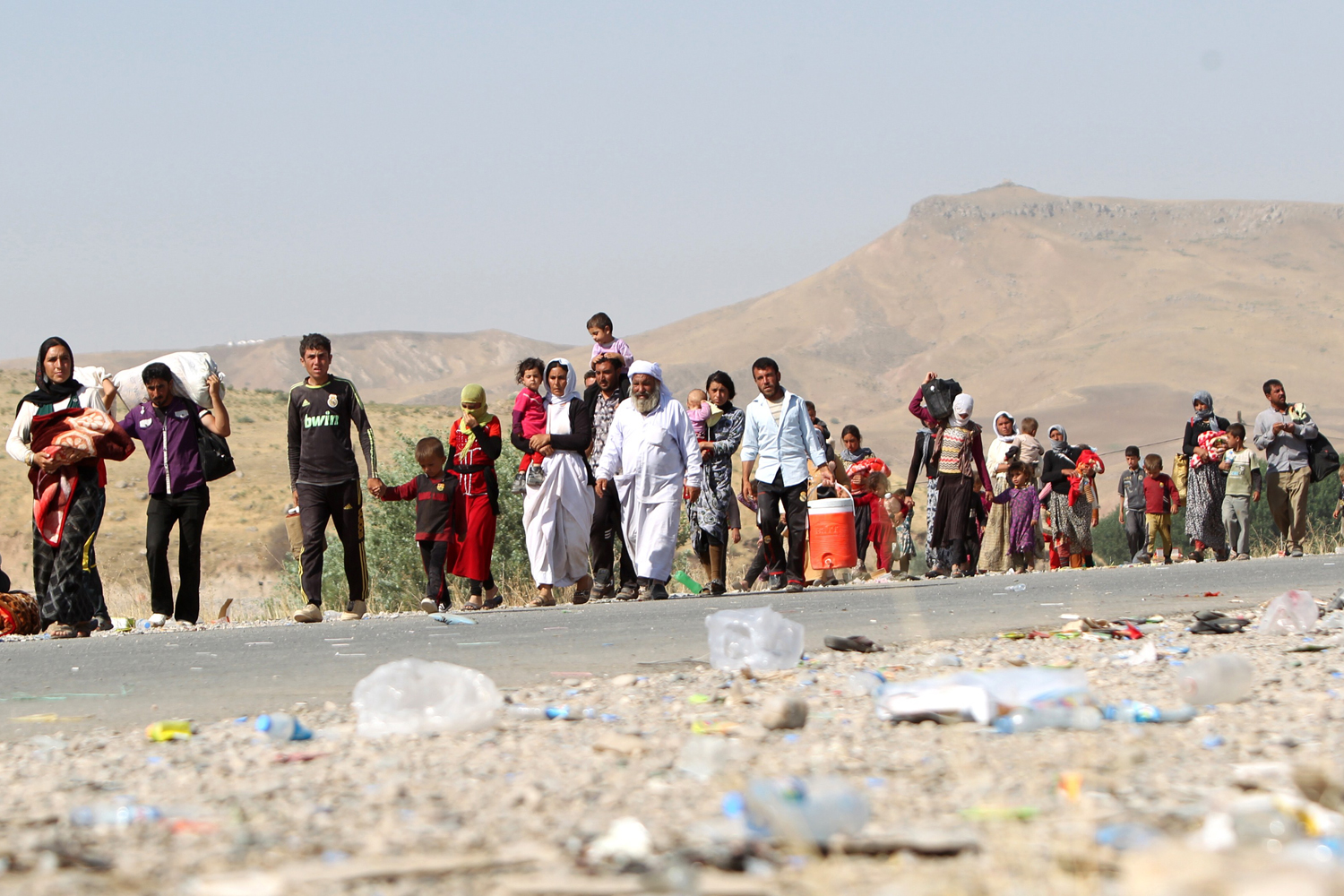 Displaced Iraqi families from the Yazidi community cross the Iraqi-Syrian border at the Fishkhabur crossing, in northern Iraq, on Aug. 13, 2014.