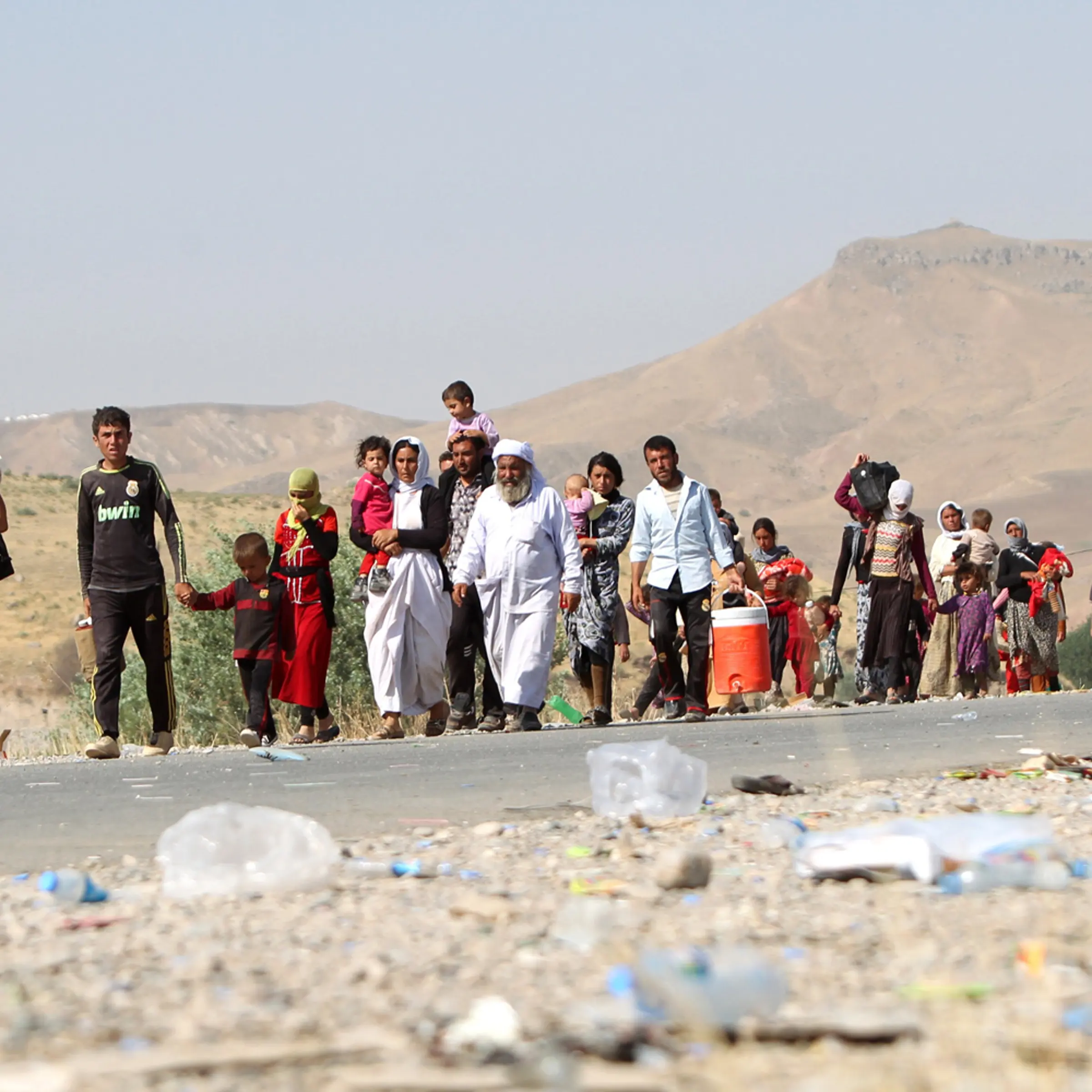 Displaced Iraqi families from the Yazidi community cross the Iraqi-Syrian border at the Fishkhabur crossing, in northern Iraq, on Aug. 13, 2014.