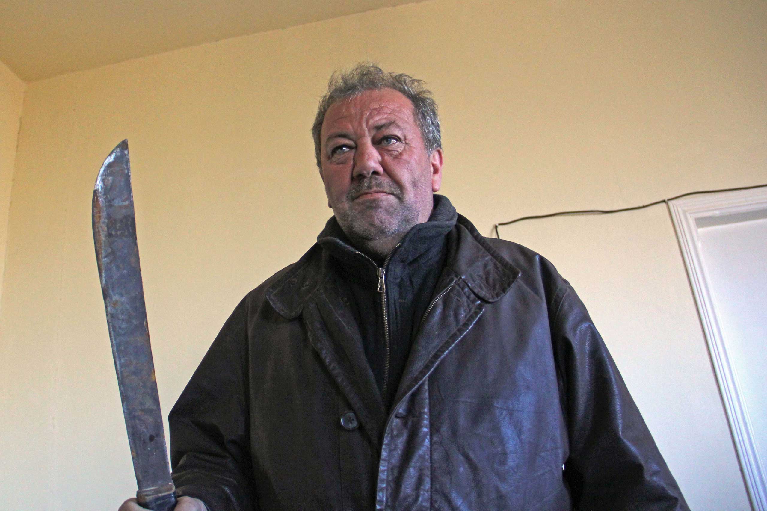 Hash dealer Ali Nasri Shamas holds up a machete he promises to use on jihadis.