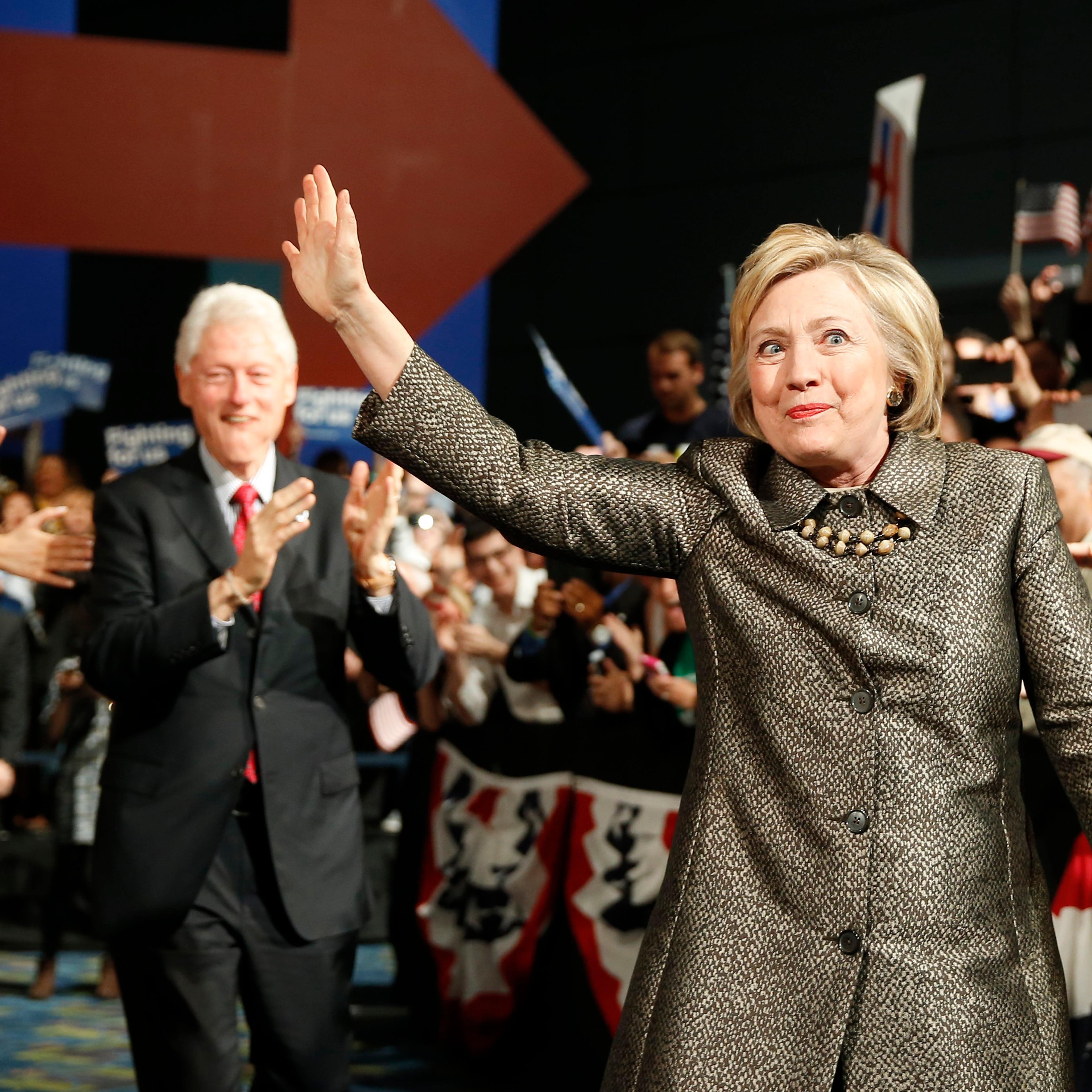 Democratic presidential candidate Hillary Clinton and former President Bill Clinton move to the stage at her presidential primary election night rally on April 26, 2016, in Philadelphia.