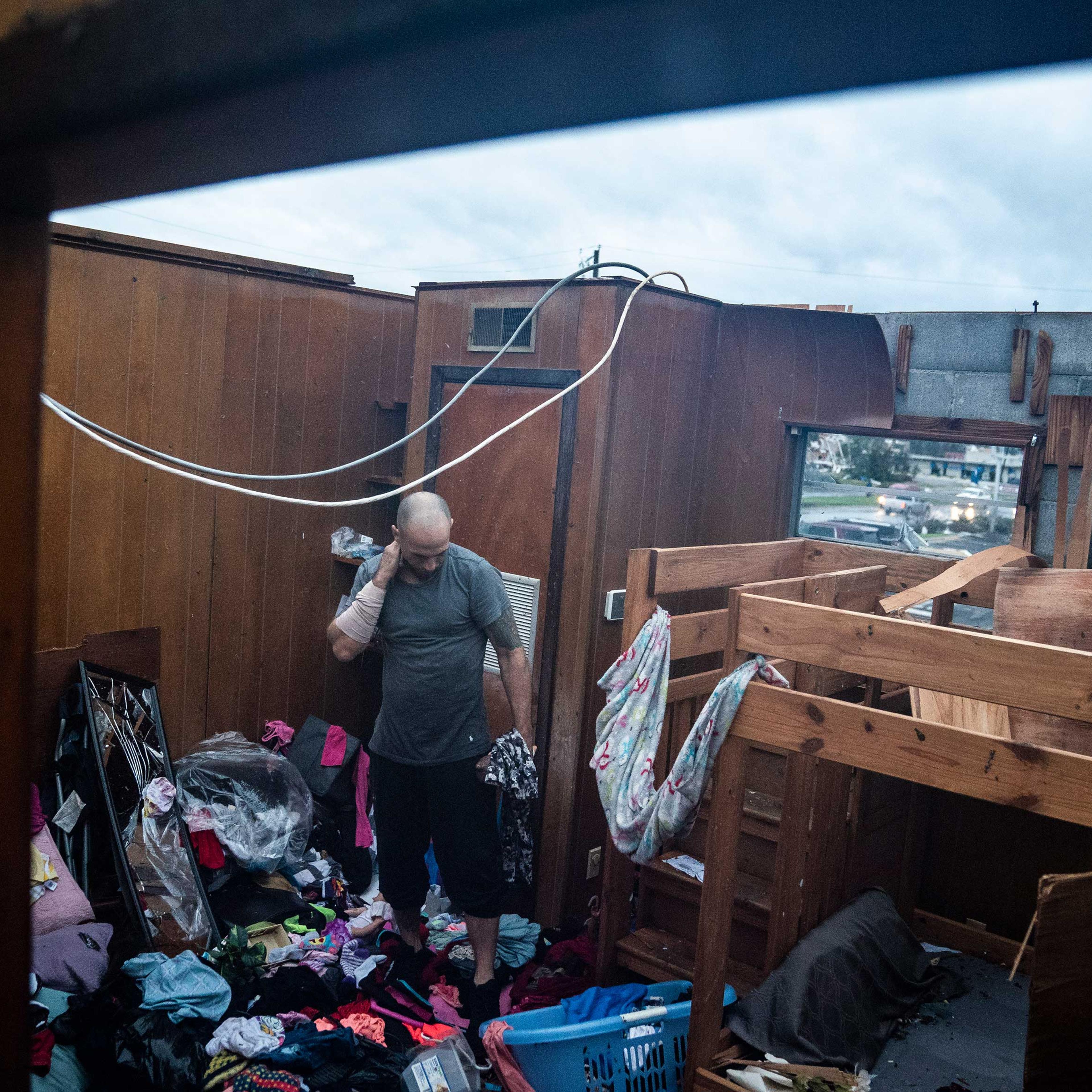 Jason Phipps looks through his families roofless apartment after category 4 Hurricane Michael made land fall along the Florida panhandle, on Oct. 10, 2018 in Panama City, Fla.
