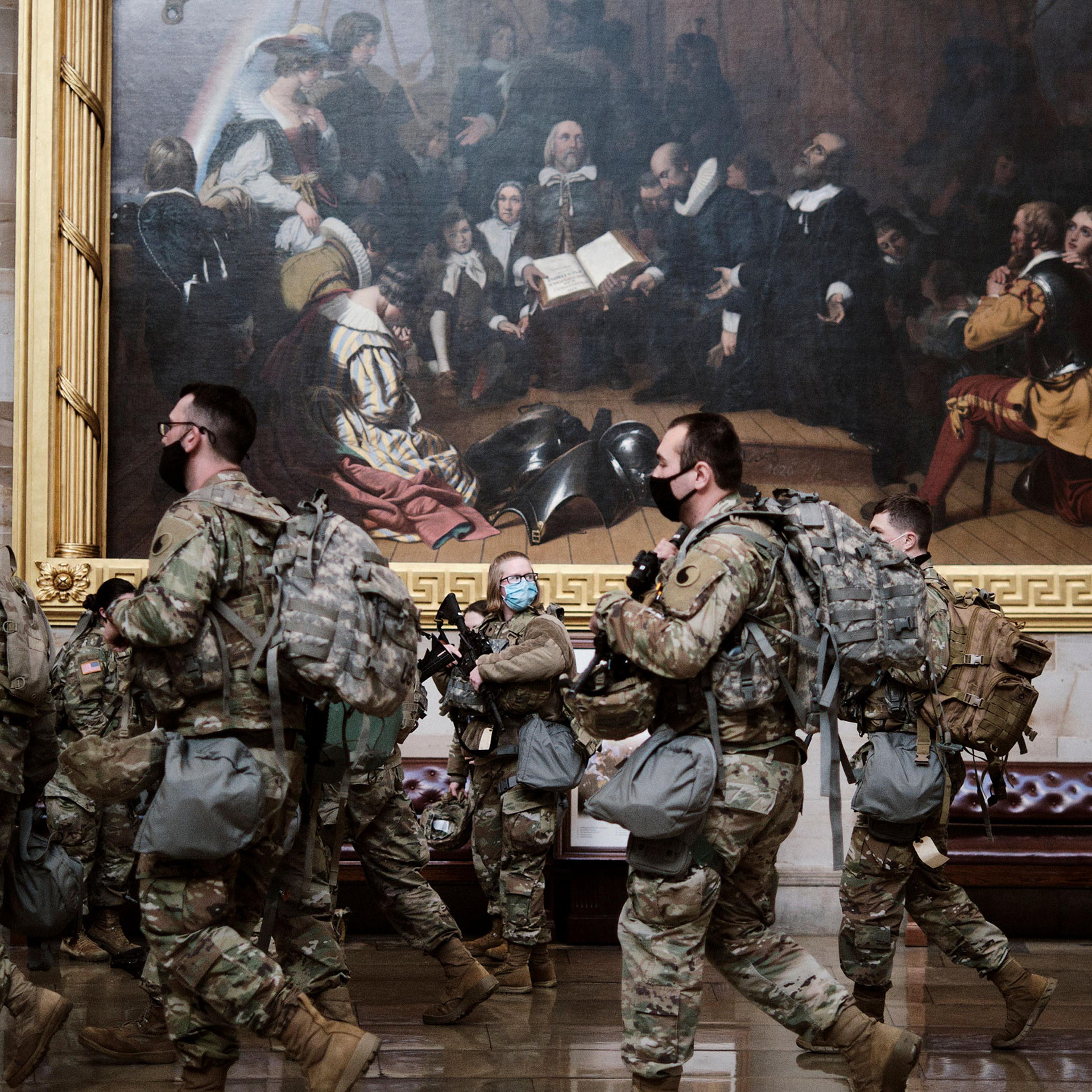 Armed National Guard troops gather in the rotunda of the Capitol in Washington on Jan. 13, 2021.