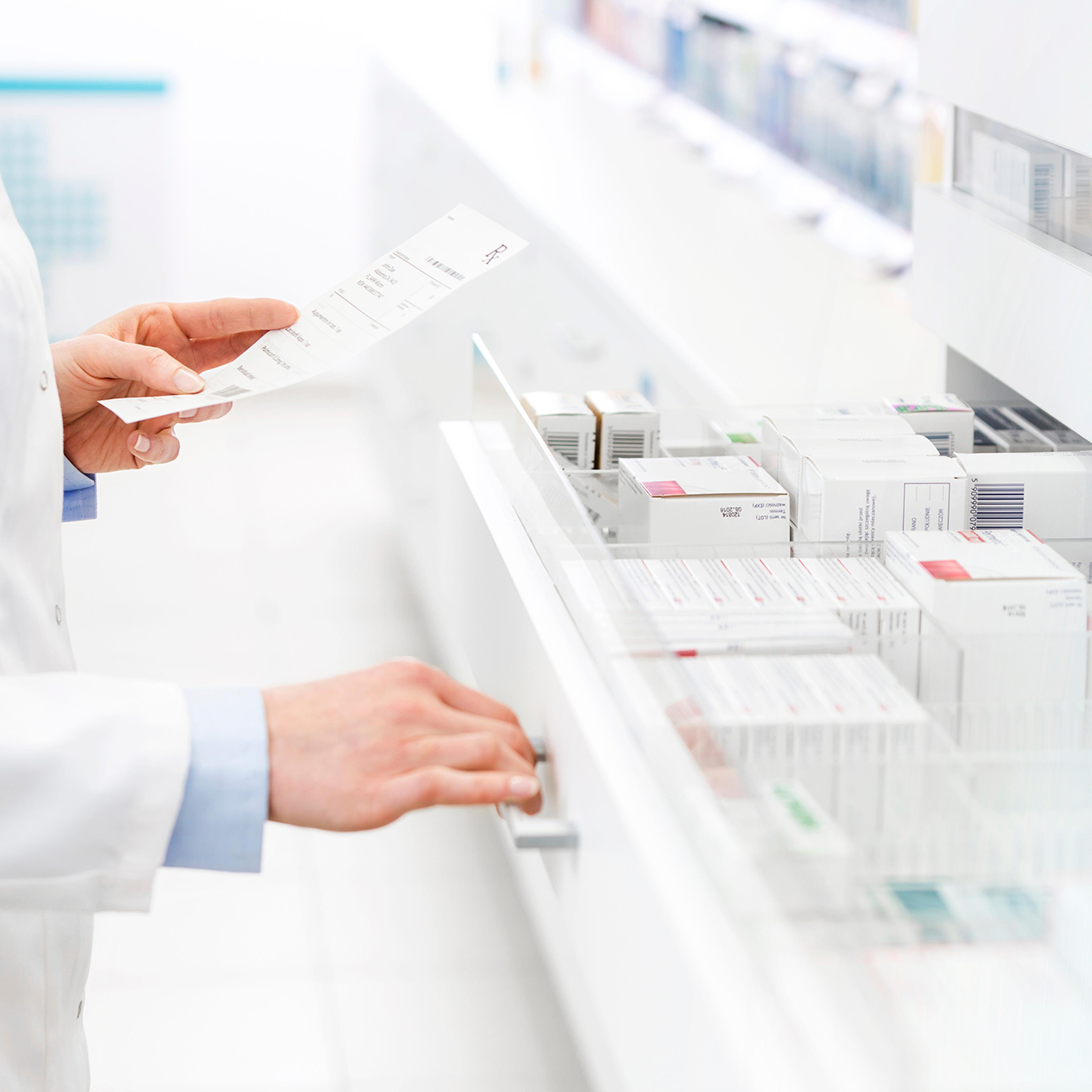 Pharmacist filling prescription in pharmacy