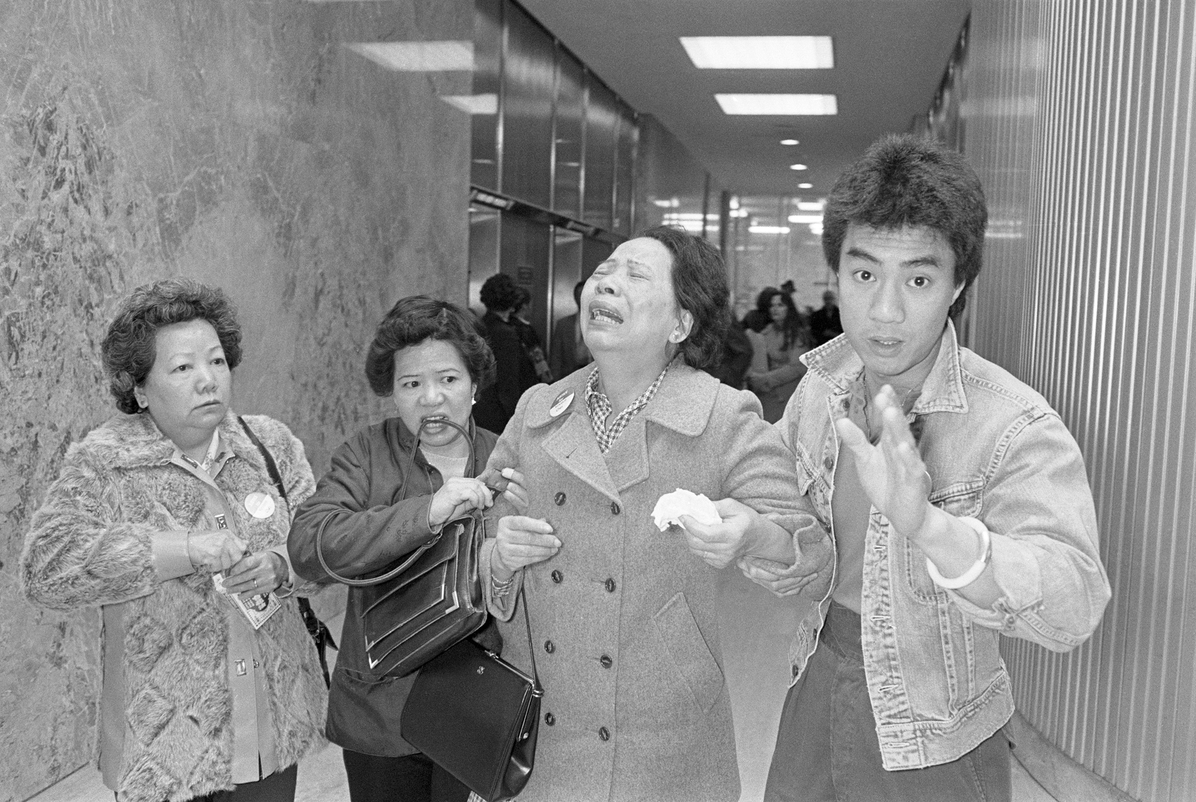 Lillie Chin, mother of Vincent chin who was clubbed to death by two white men in June 1982, breaks down as a relative (L), helps her walk while leaving Detroit's City County Building. Mrs. Chin along with the American Citizens for Justice are asking Judg