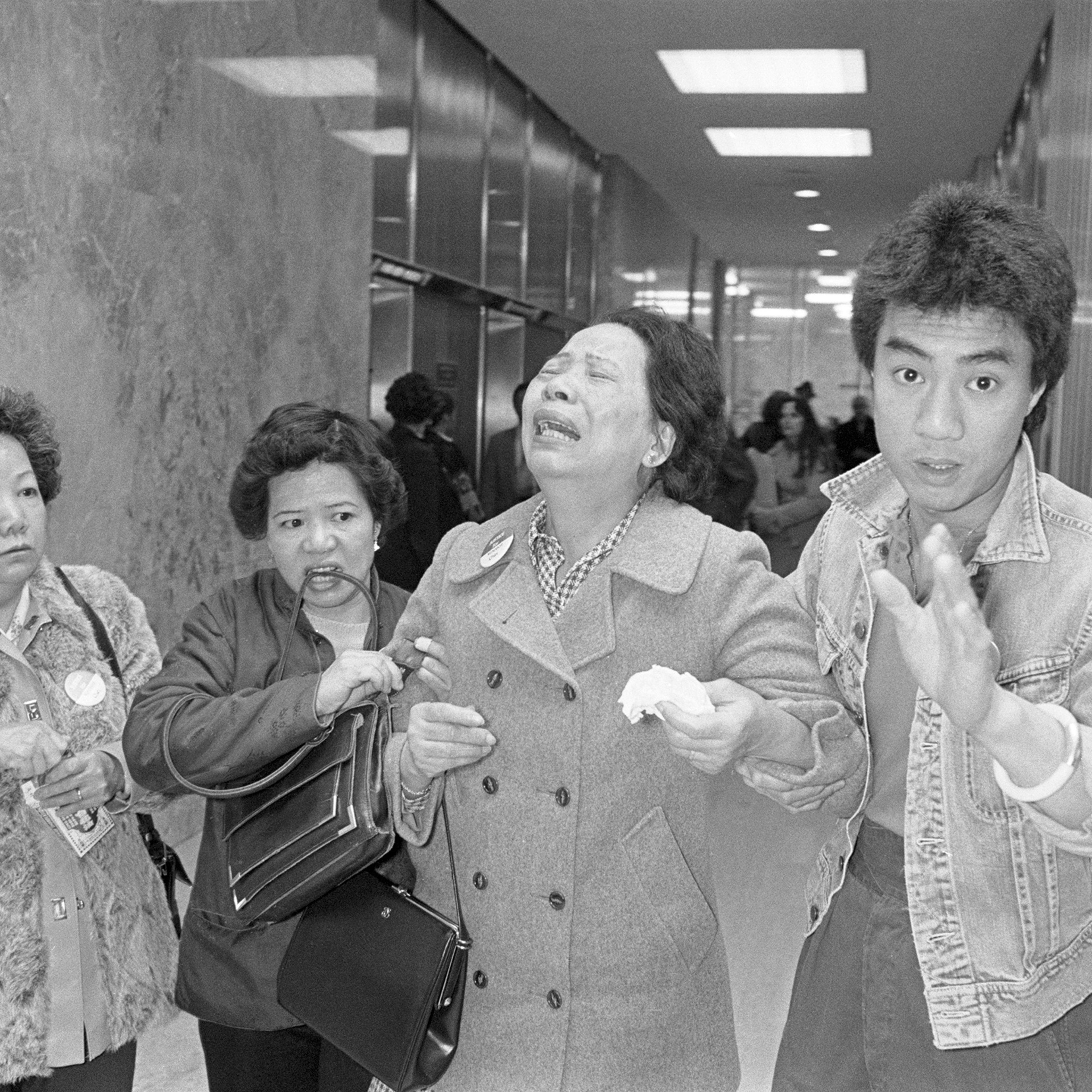 Lillie Chin, mother of Vincent chin who was clubbed to death by two white men in June 1982, breaks down as a relative (L), helps her walk while leaving Detroit's City County Building. Mrs. Chin along with the American Citizens for Justice are asking Judg