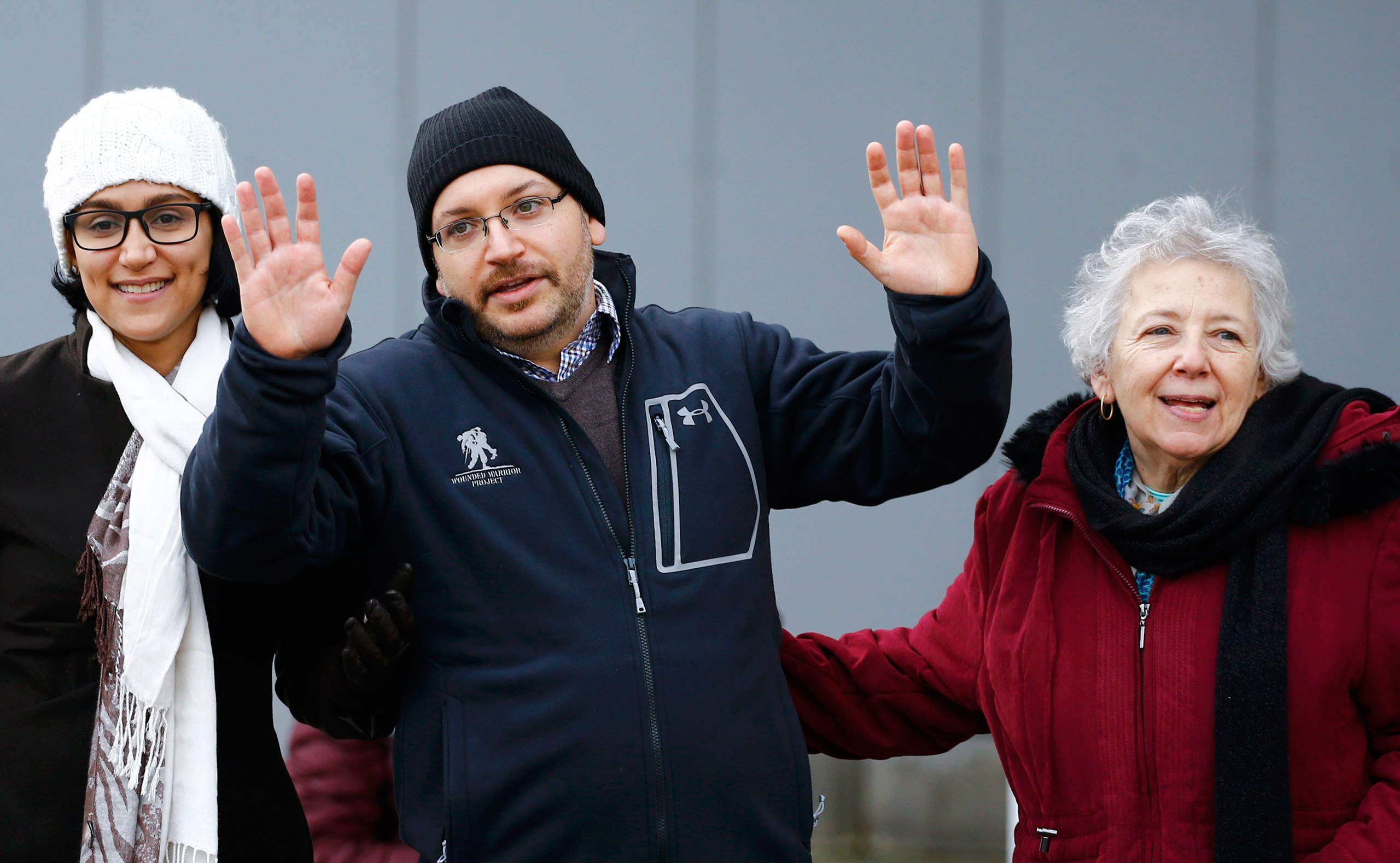 Jason Rezaian (C), one of the U.S. citizens recently released from detention in Iran, waves to media as he stands with his wife Yeganeh Salehi (L) and mother Mary Rezaian outside the Emergency Room of the Landstuhl Regional Medical Center (LRMC) in the s
