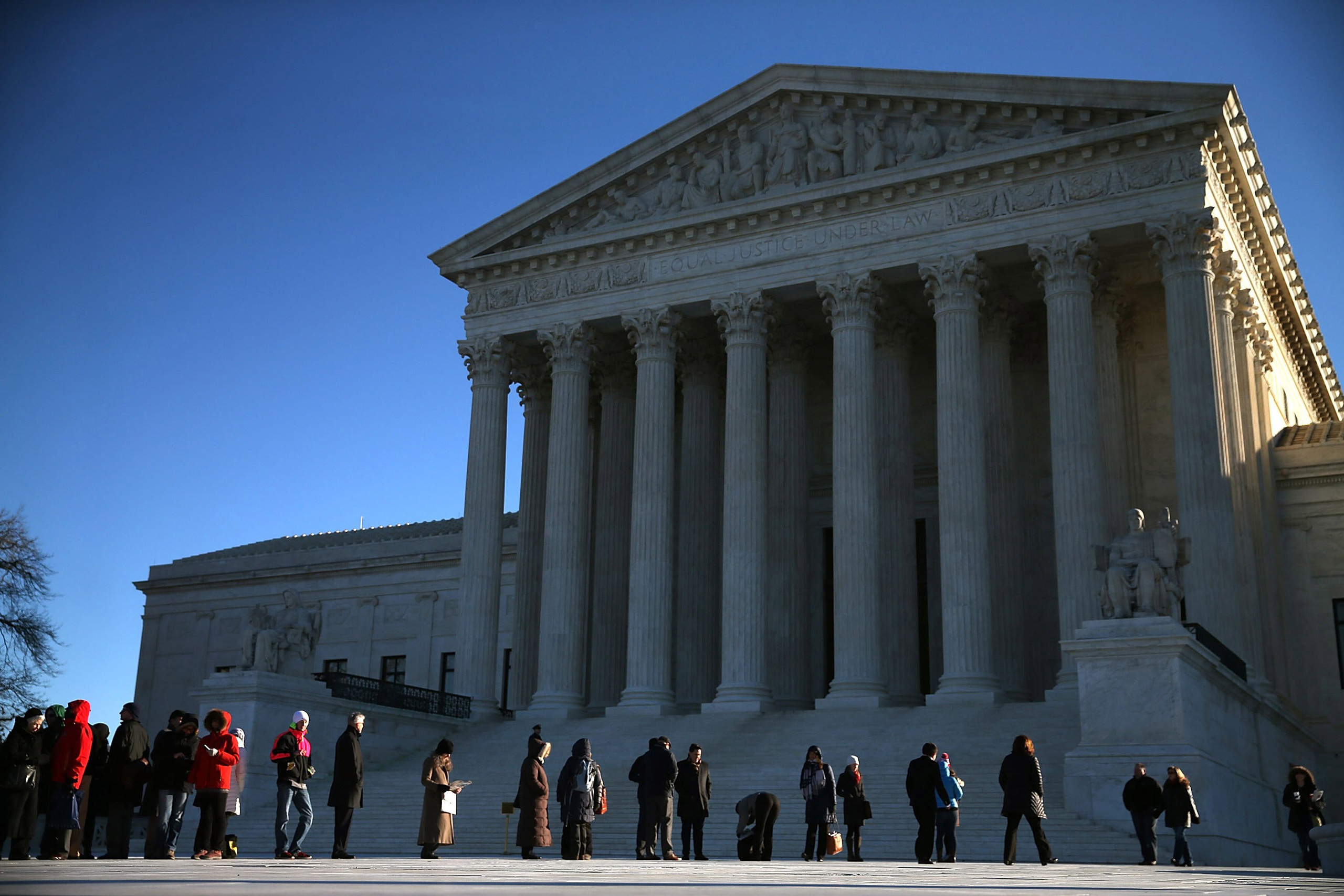 WASHINGTON, DC - JANUARY 11: People wait in line to enter the US Supreme Court building January 11, 2016 in Washington, DC. The high court is hearing arguments in the Friedrichs v. California Teachers Association case. The case will decide whether Califo