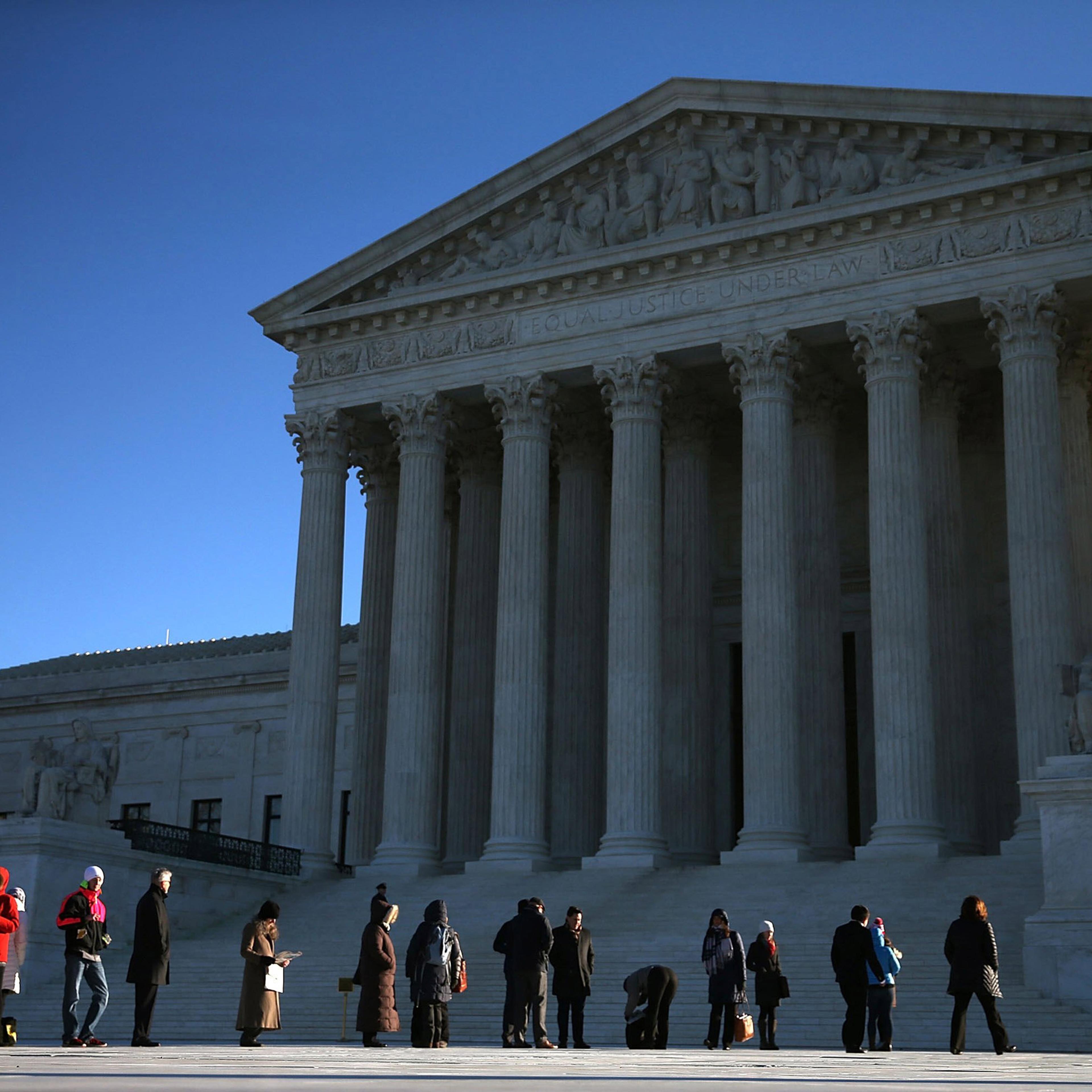 WASHINGTON, DC - JANUARY 11: People wait in line to enter the US Supreme Court building January 11, 2016 in Washington, DC. The high court is hearing arguments in the Friedrichs v. California Teachers Association case. The case will decide whether Califo