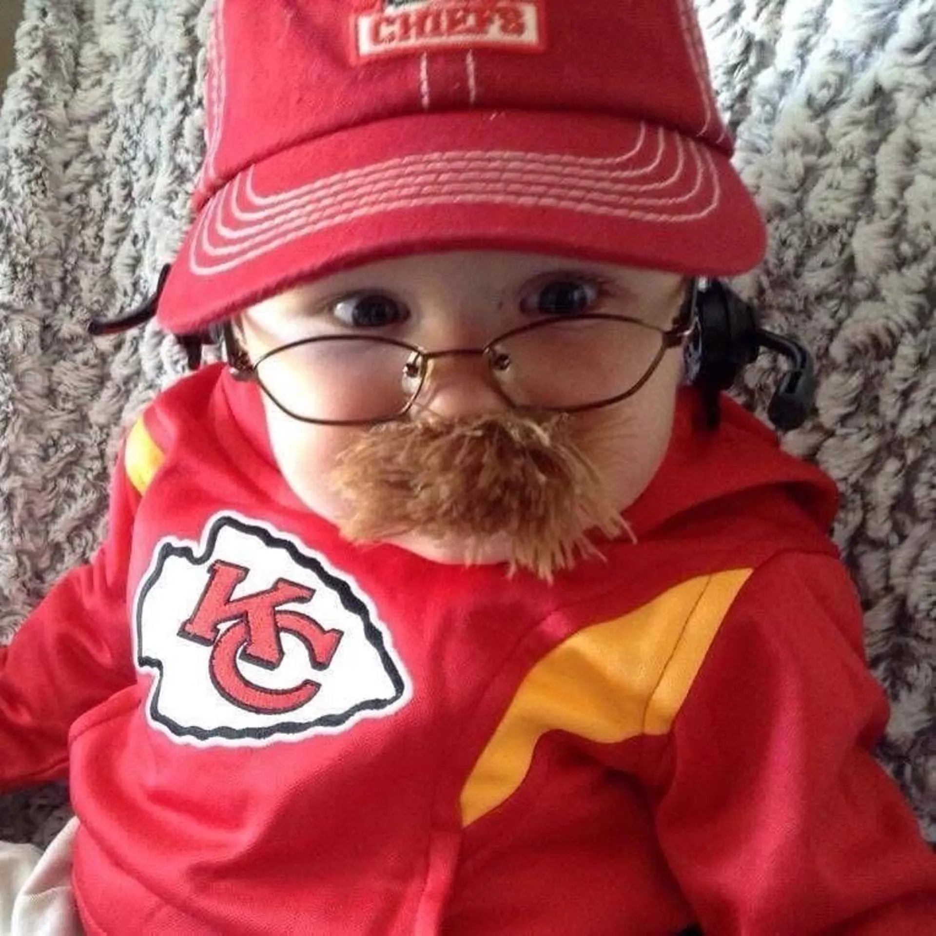 Graham Leeper in 2013, at five months, dressed as Kansas City Chiefs coach Andy Reid for Halloween. The photo went viral and has inspired copycat costumes over the last decade.
