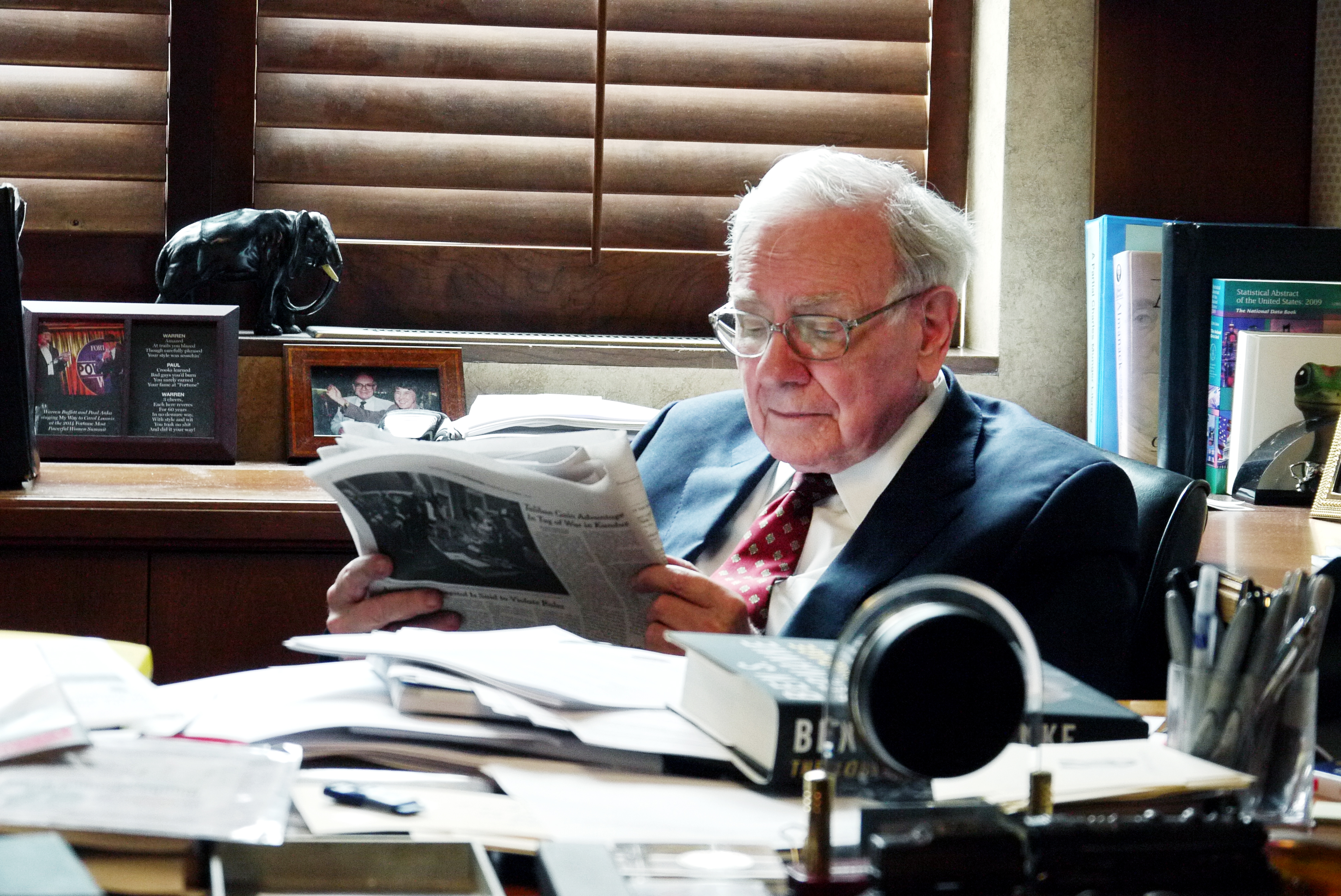 Warren Buffett in his Berkshire Hathaway office in Omaha, Nebraska. He has been known to read six national and local newspapers a day, TIME magazine reported in its July 6, 2015, issue. 