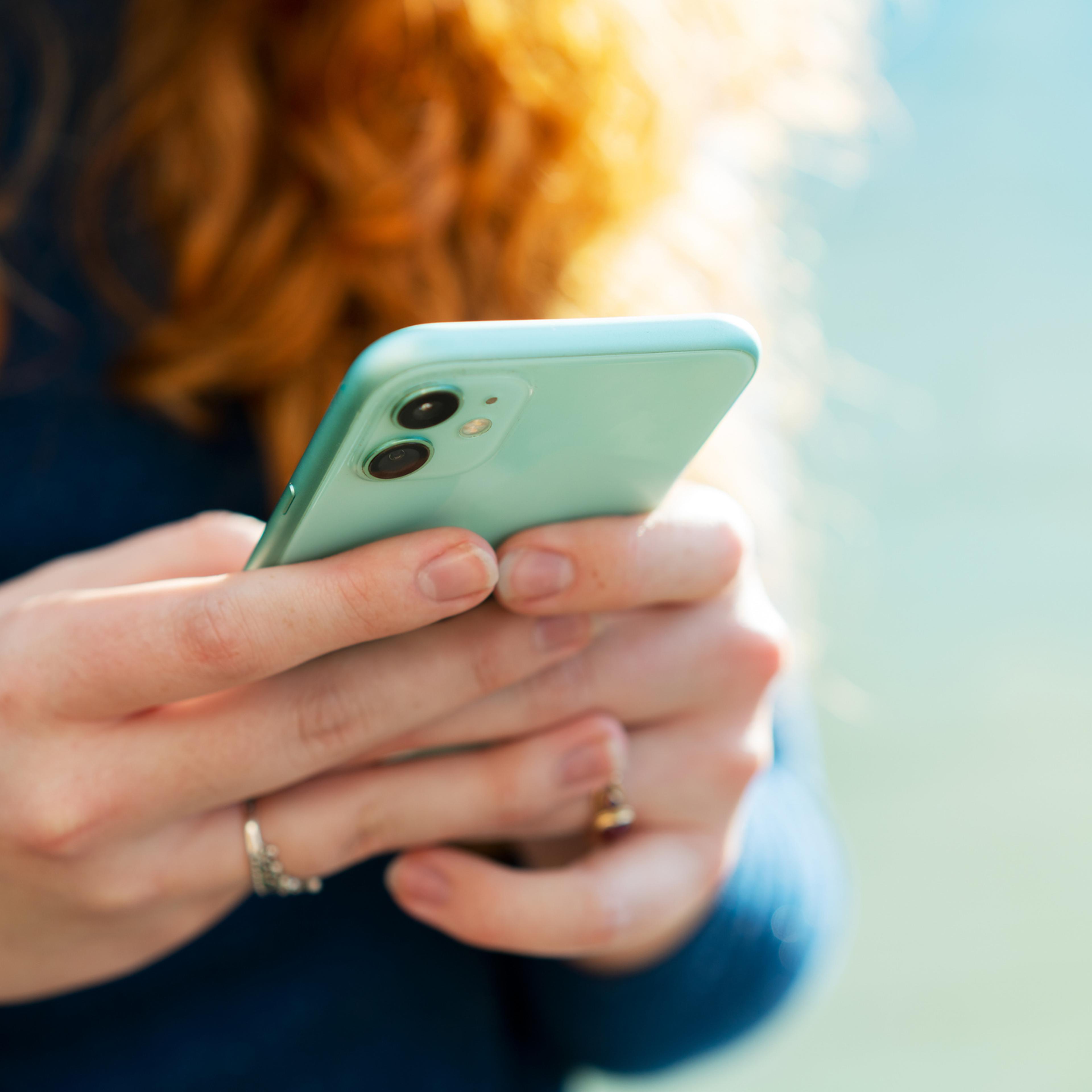 Close up or woman using smart phone