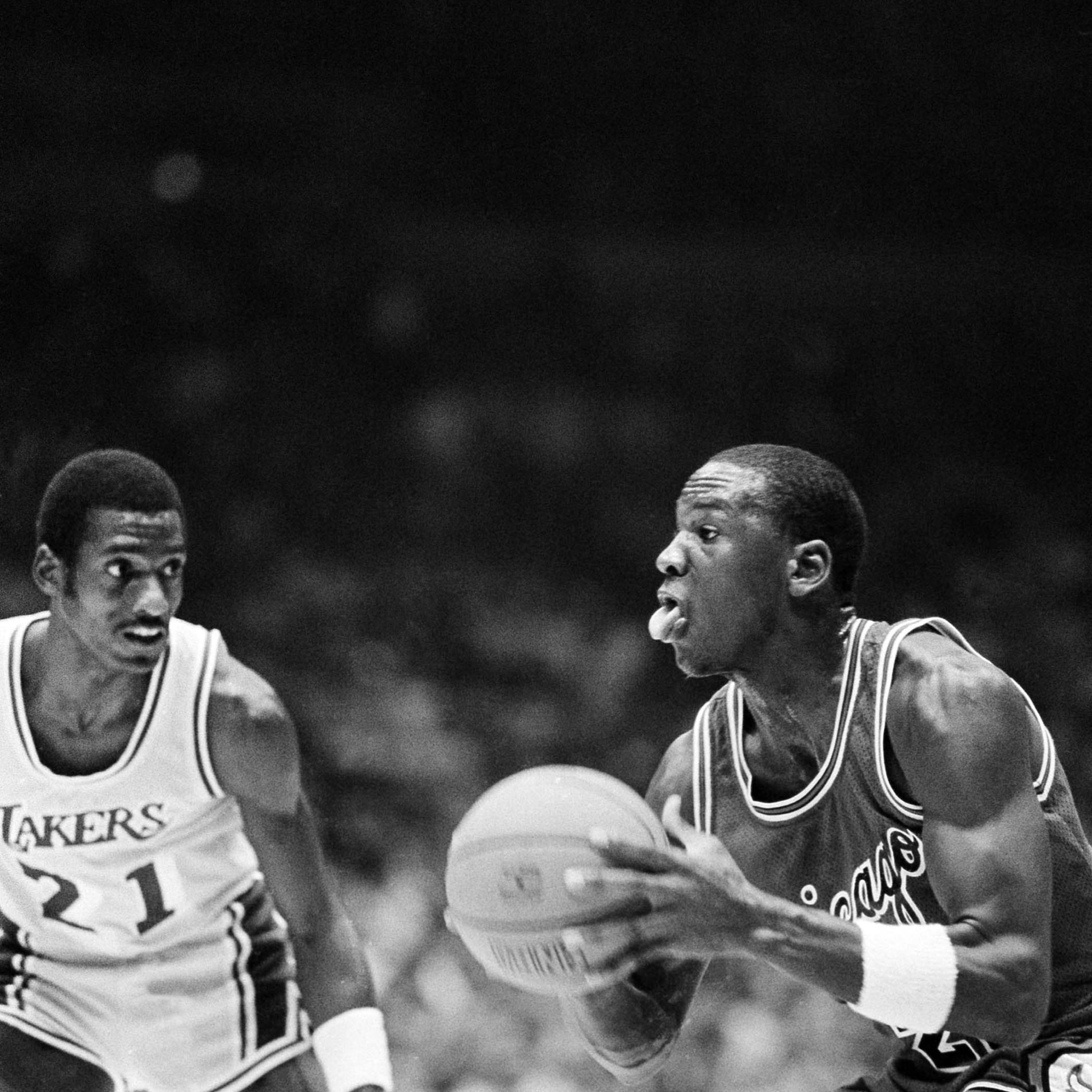 Chicago Bulls' Michael Jordan (23), right, prepares to go up with the ball as Los Angeles Lakers guard Michael Cooper (21), looks on during first half NBA action at the Forum in Inglewood, Calif., Dec. 2, 1984