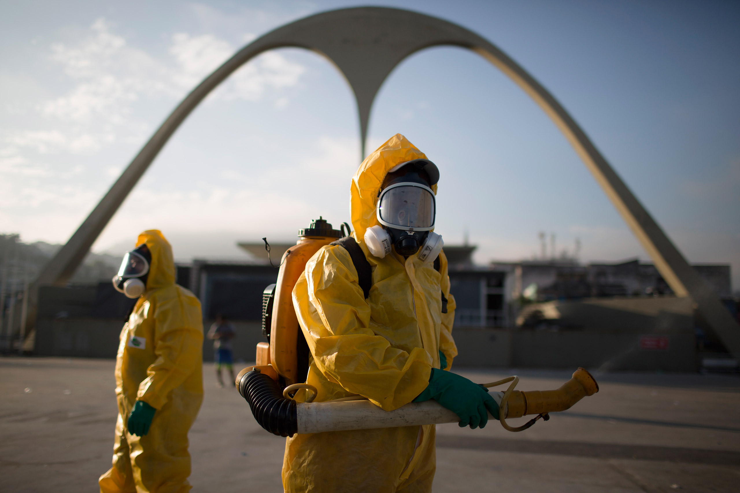 FILE - In this Tuesday, Jan. 26, 2016 file photo, a health workers stands in the Sambadrome spraying insecticide to combat the Aedes aegypti mosquito that transmits the Zika virus in Rio de Janeiro, Brazil. In the 1940s and 1950s, Brazilian authorities m