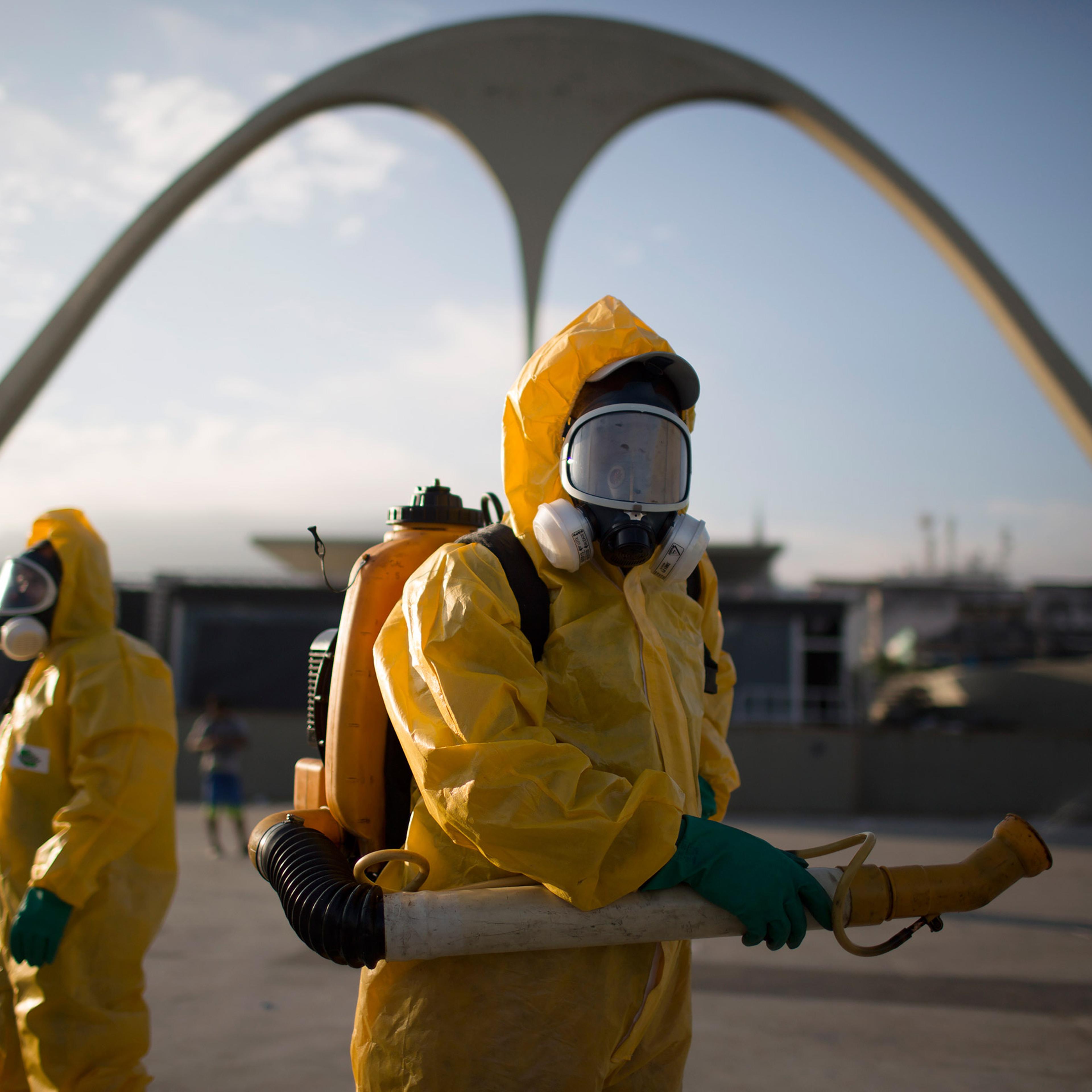 FILE - In this Tuesday, Jan. 26, 2016 file photo, a health workers stands in the Sambadrome spraying insecticide to combat the Aedes aegypti mosquito that transmits the Zika virus in Rio de Janeiro, Brazil. In the 1940s and 1950s, Brazilian authorities m