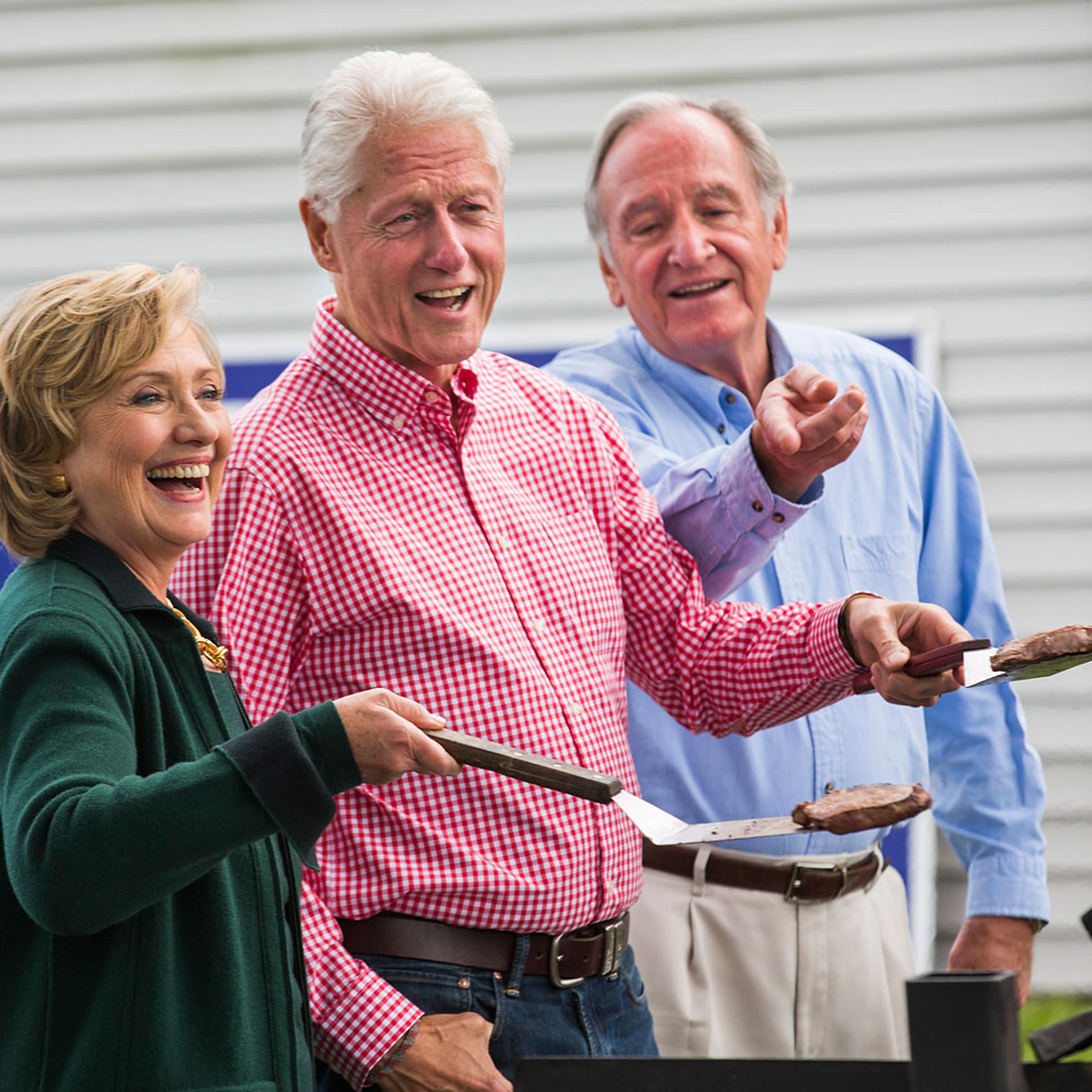 Hillary and Bill Clinton cook steaks with Iowa Senator Tom Harken at his annual Steak Fry in Indianola, Iowa