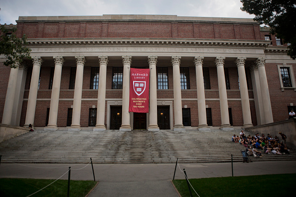 Students and visitors pass by the Widener Library on the Harvard University Campus in Cambridge, MA, Tuesday June 30, 2015.