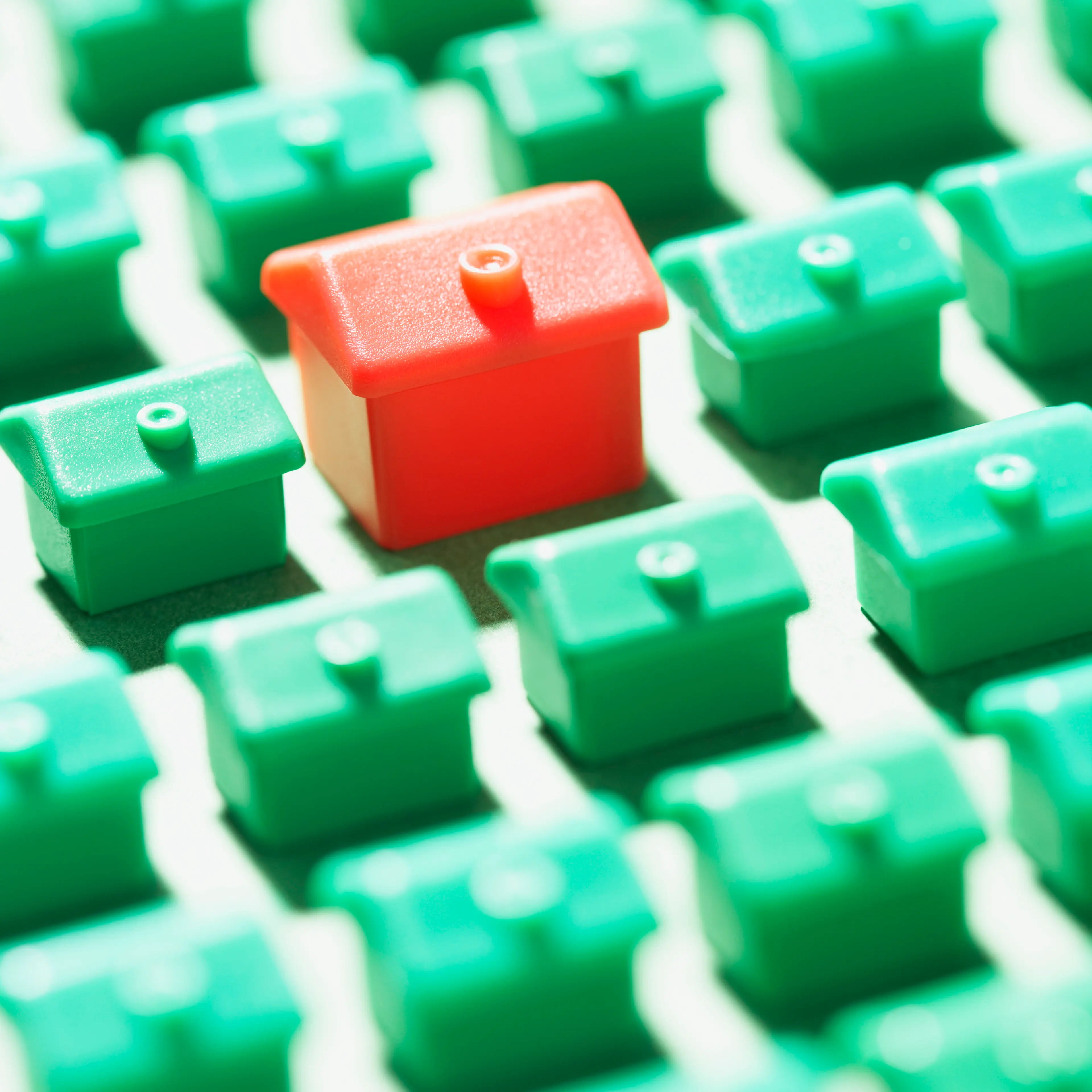 many-green-houses-large-red-house
