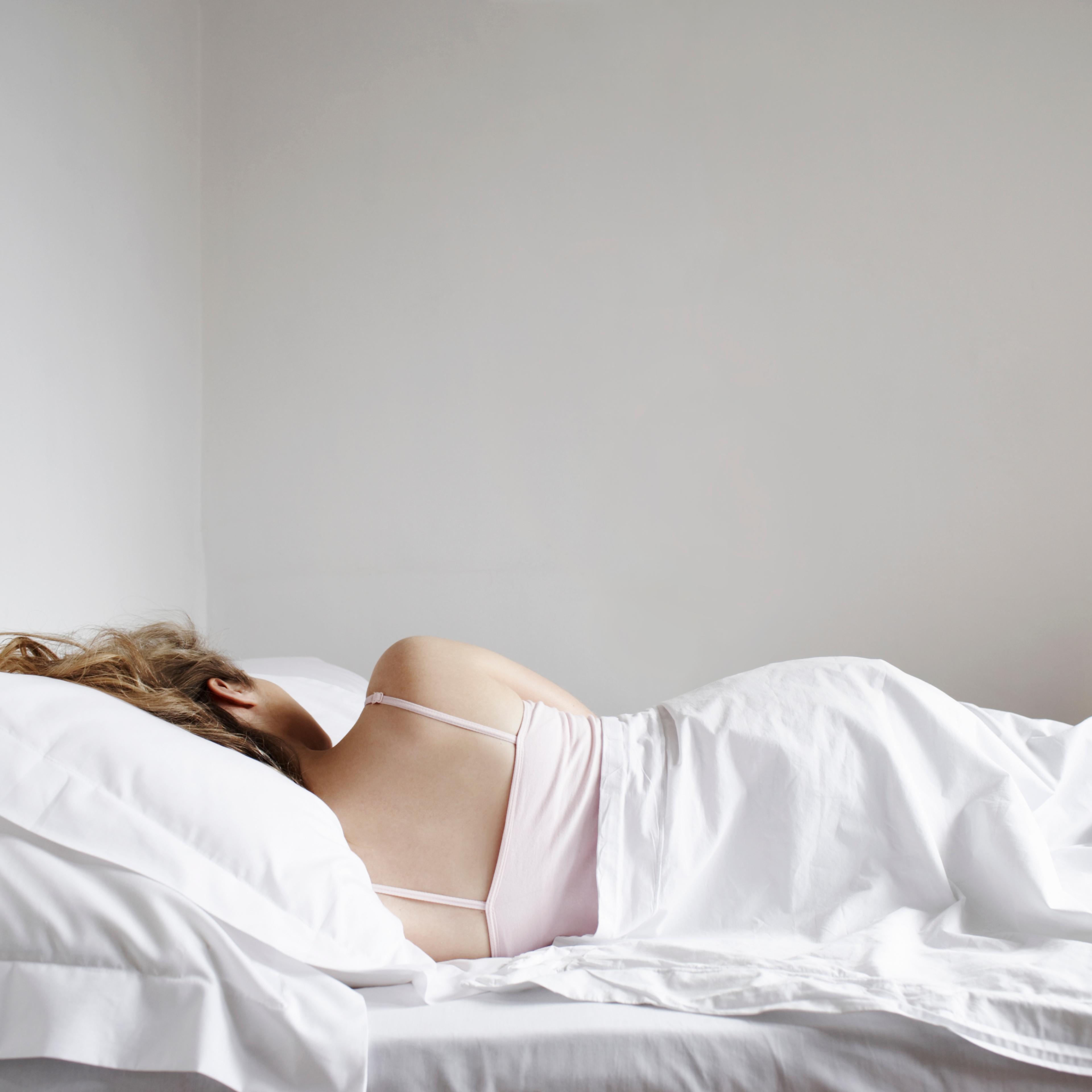 Portrait of woman sleeping in bed