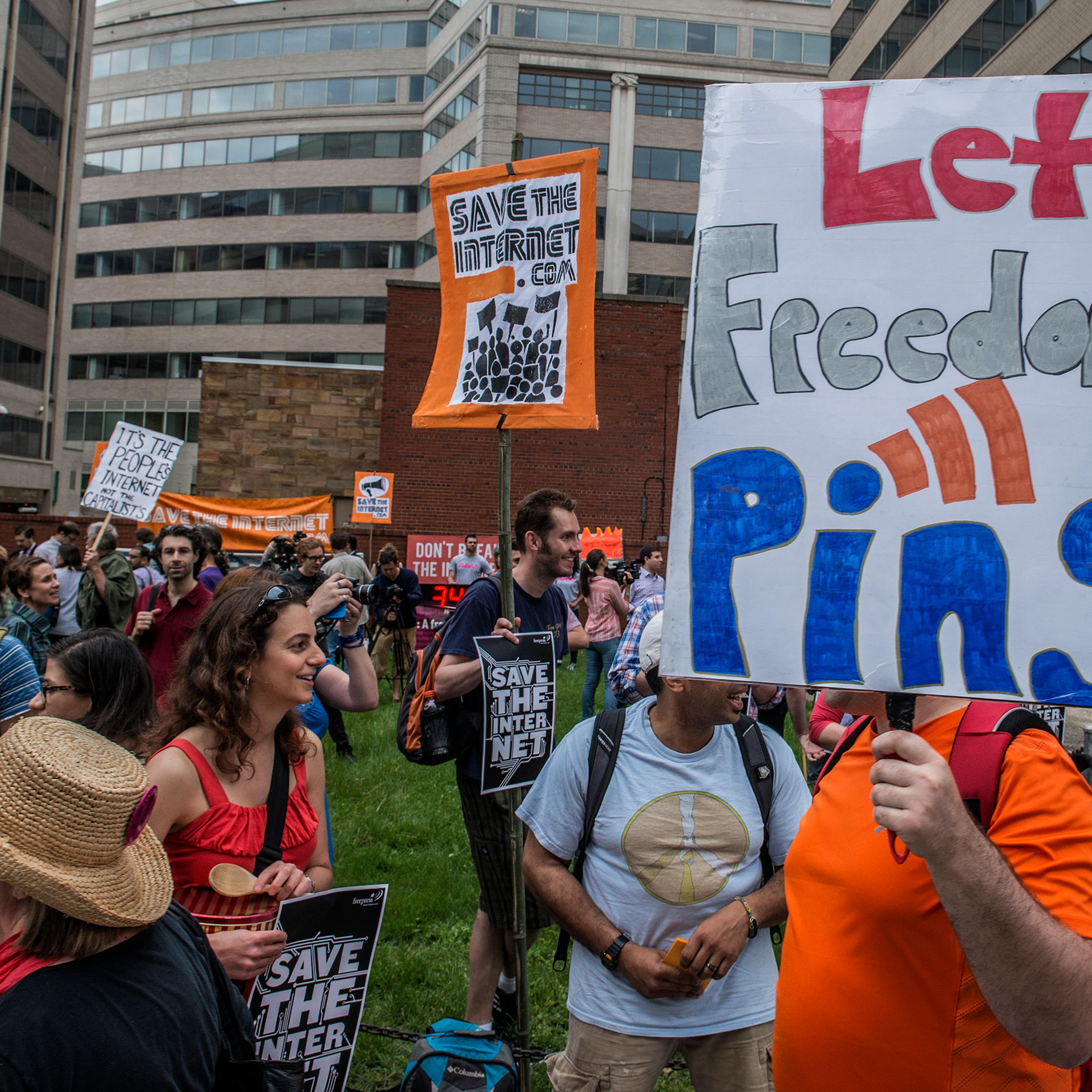 Protesters hold a rally before the FCC meeting on net neutrality proposal in Washington, DC.