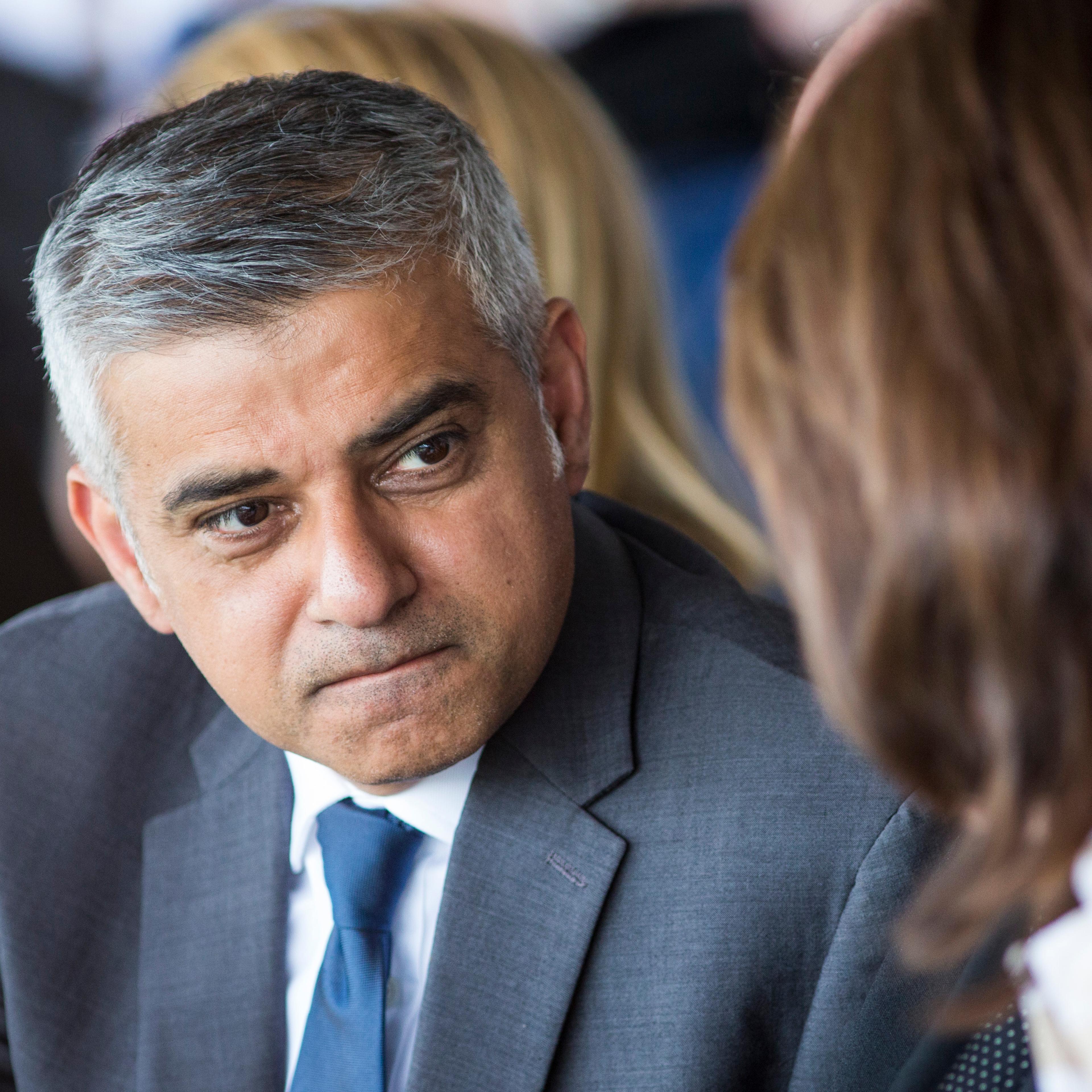 Sadiq Khan speaks with a guest at Yom HaShoah, the Jewish Community's Holocaust Remembrance Day in London on May 8, 2016.