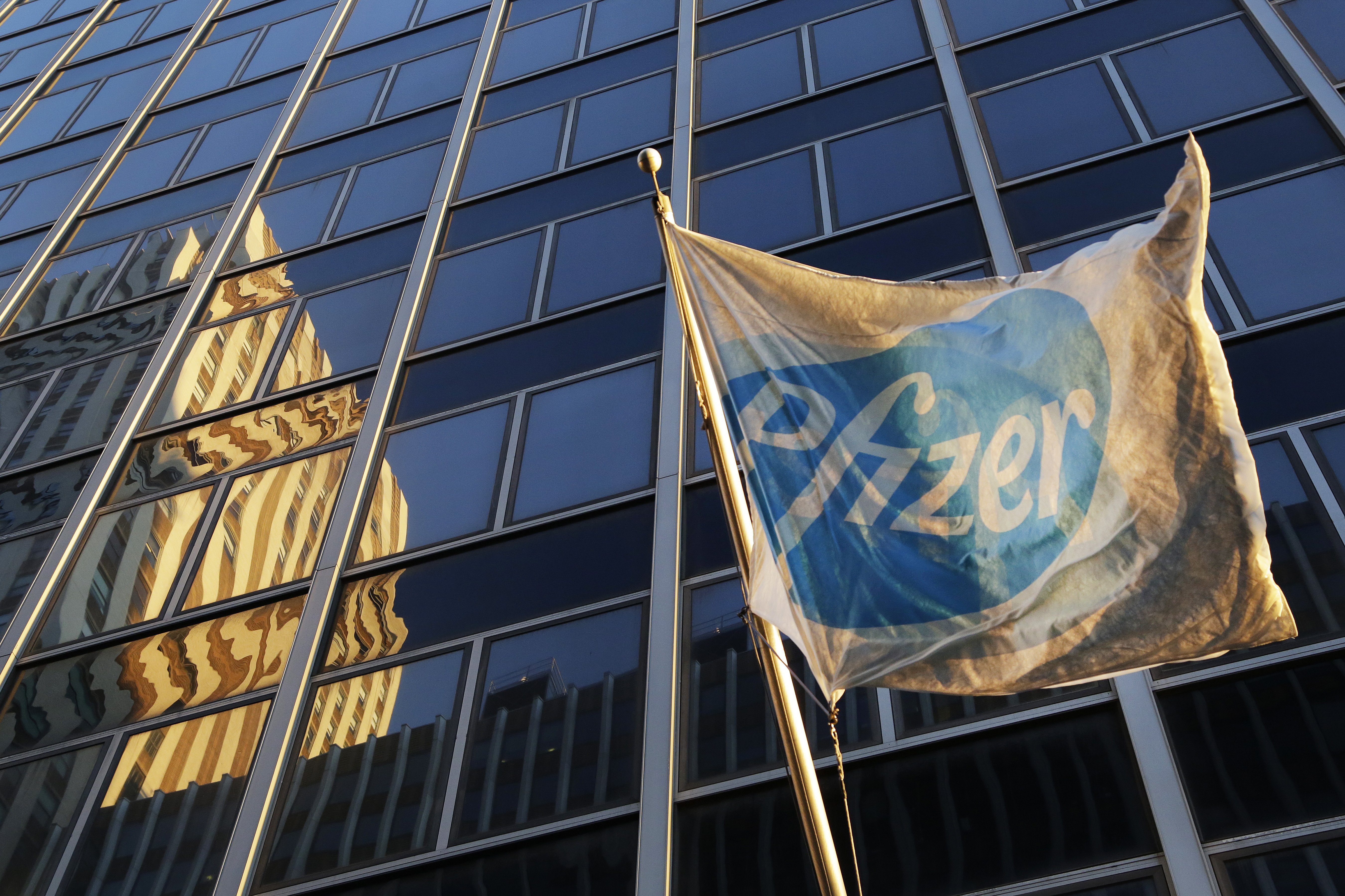 A Pfizer flag is displayed in front of world headquarters in New York on Nov. 23, 2015.