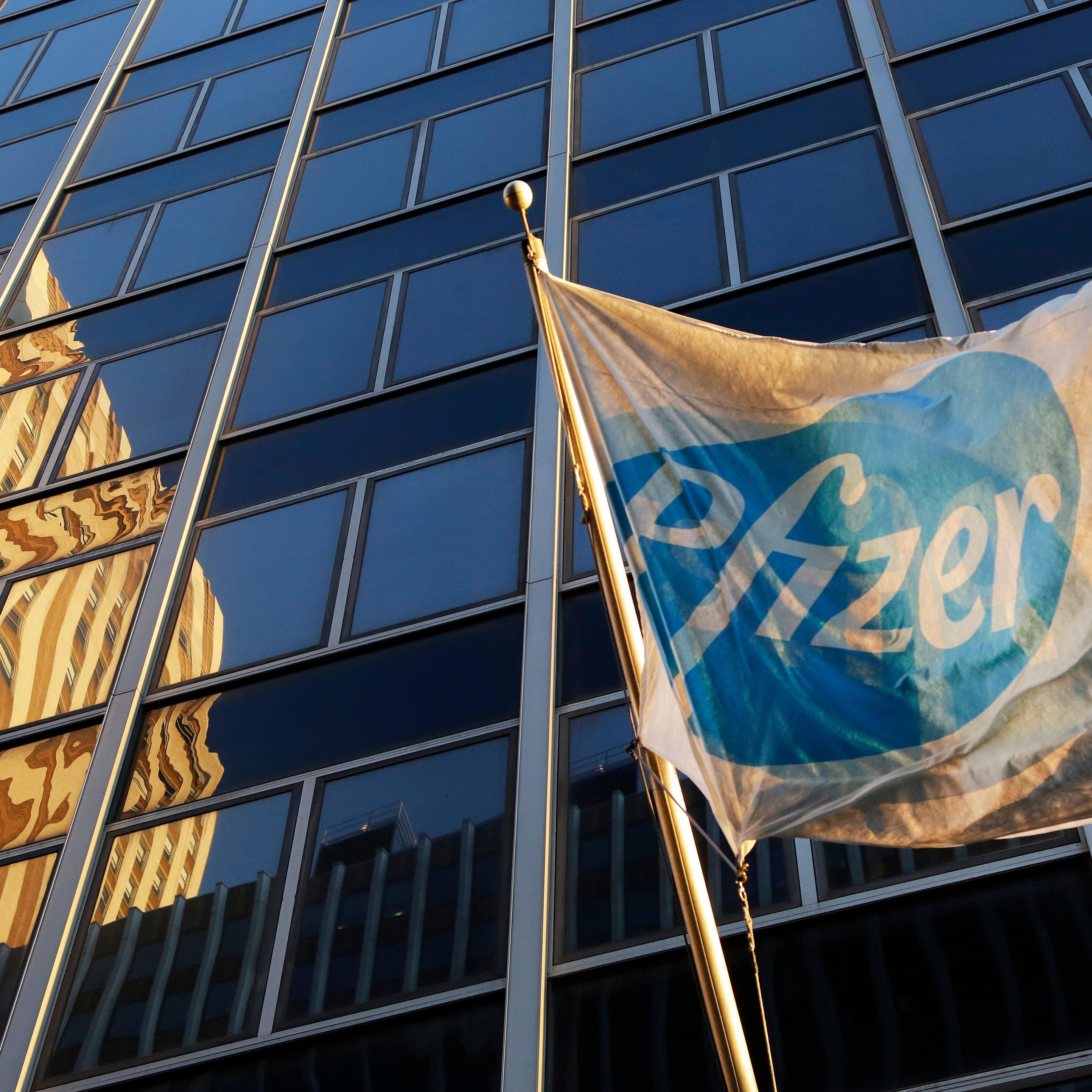 A Pfizer flag is displayed in front of world headquarters in New York on Nov. 23, 2015.