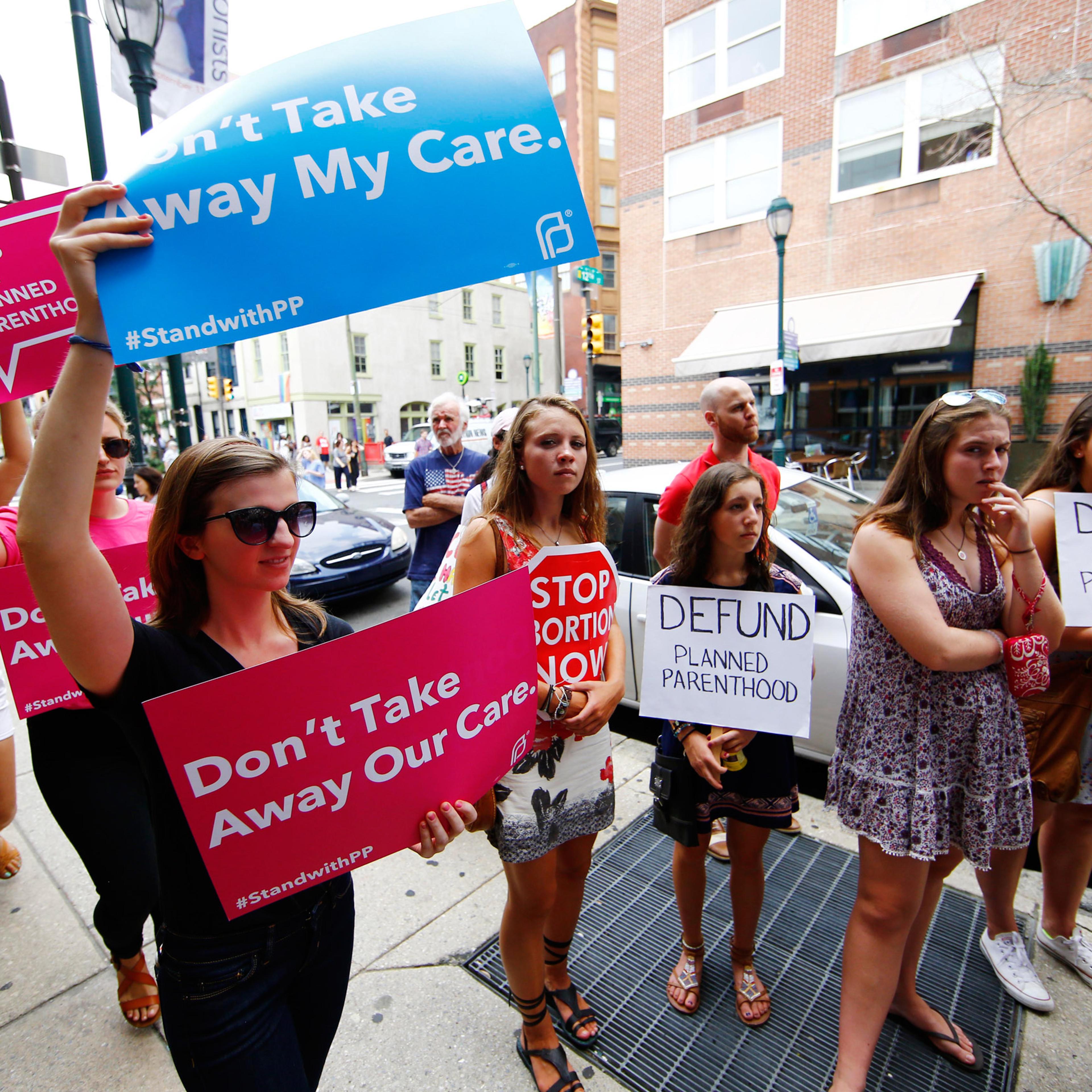 Opponents and supporters of Planned Parenthood demonstrate Tuesday, July 28, 2015, in Philadelphia. Anti-abortion activists are calling for an end to government funding for the nonprofit reproductive services organization. (AP Photo/Matt Rourke)
