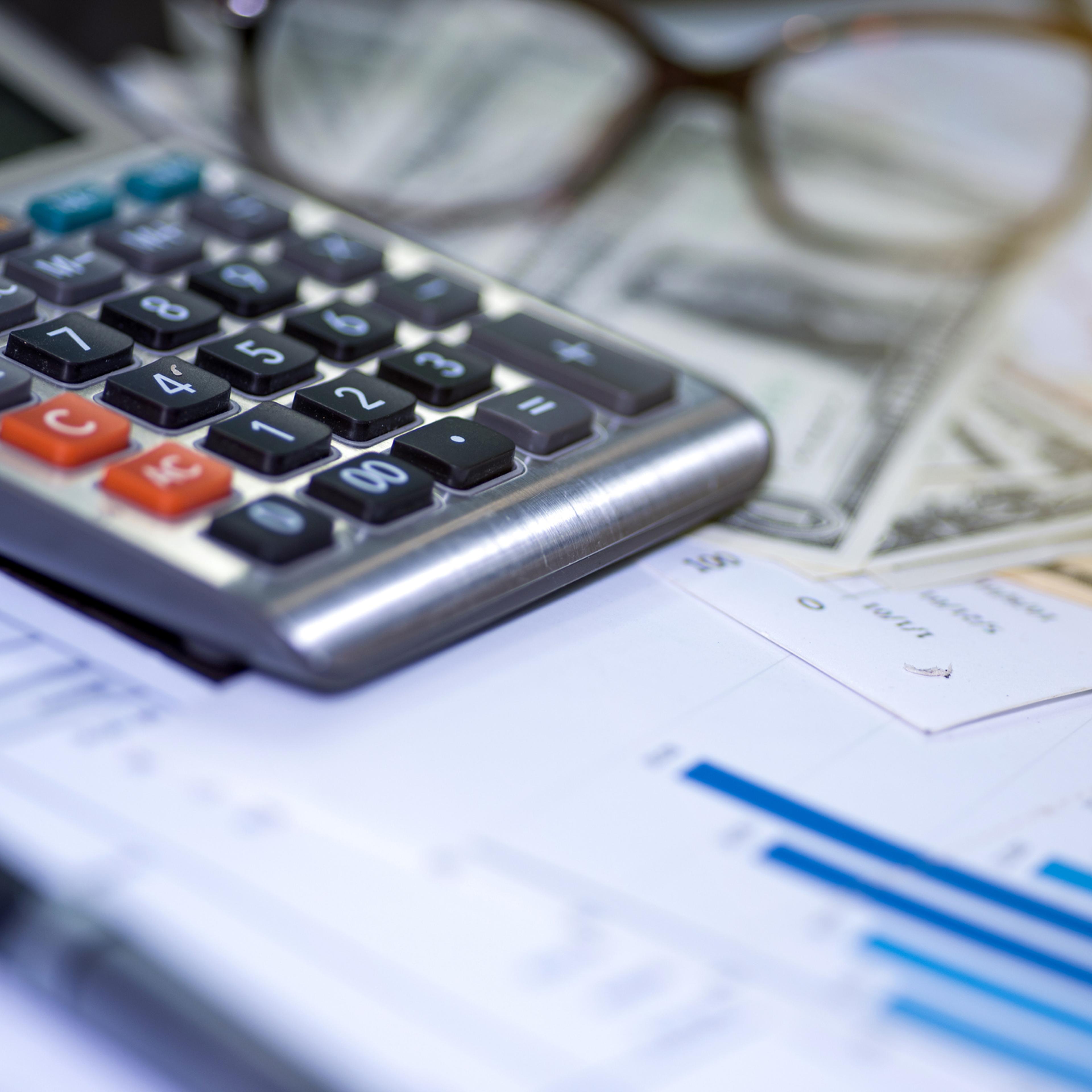 Calculator, pen and summary report. paperwork.Business planning and management concept.