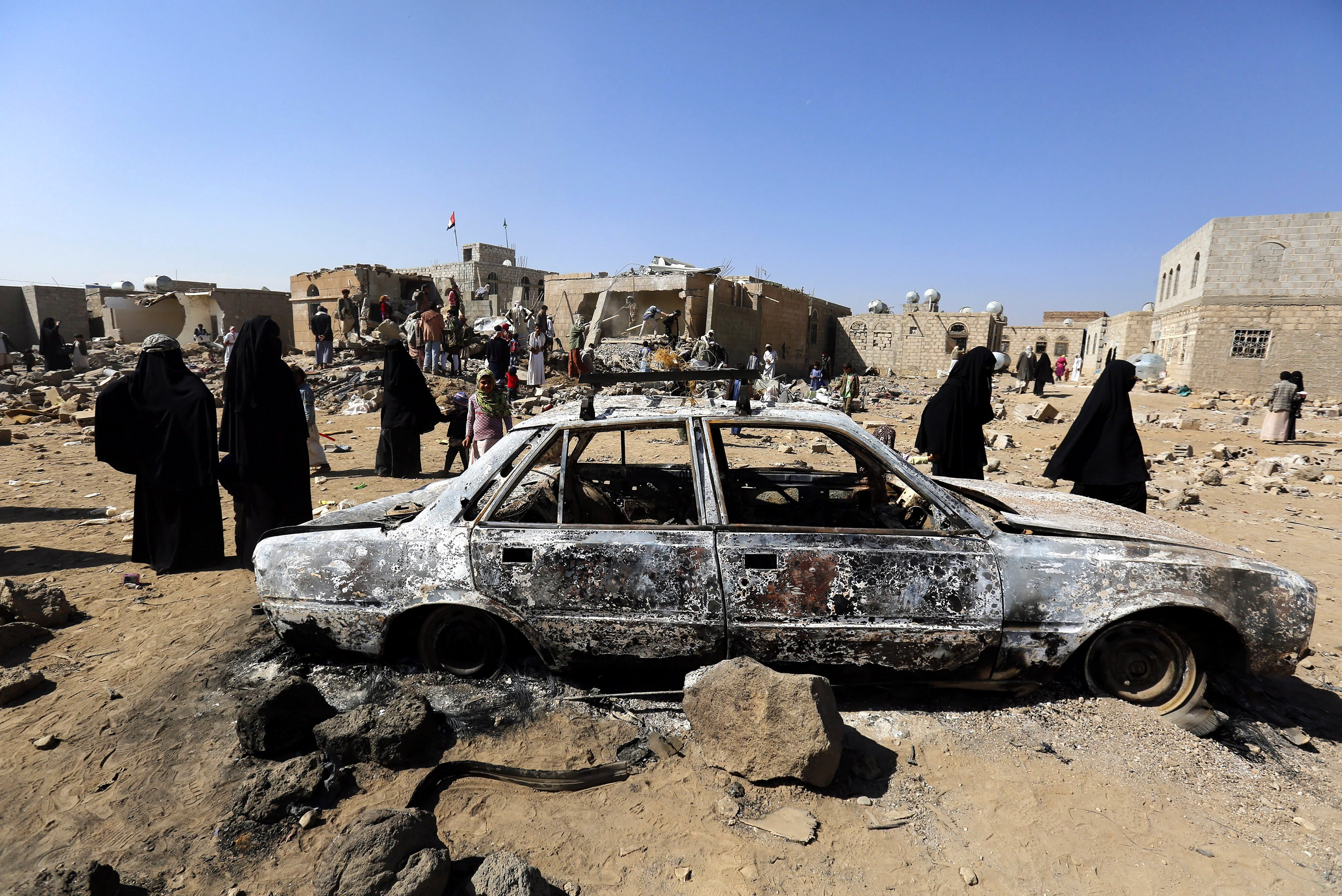 Yemenis inspect the site of a Saudi-led air strike in the city of Sana‘a on Feb. 1