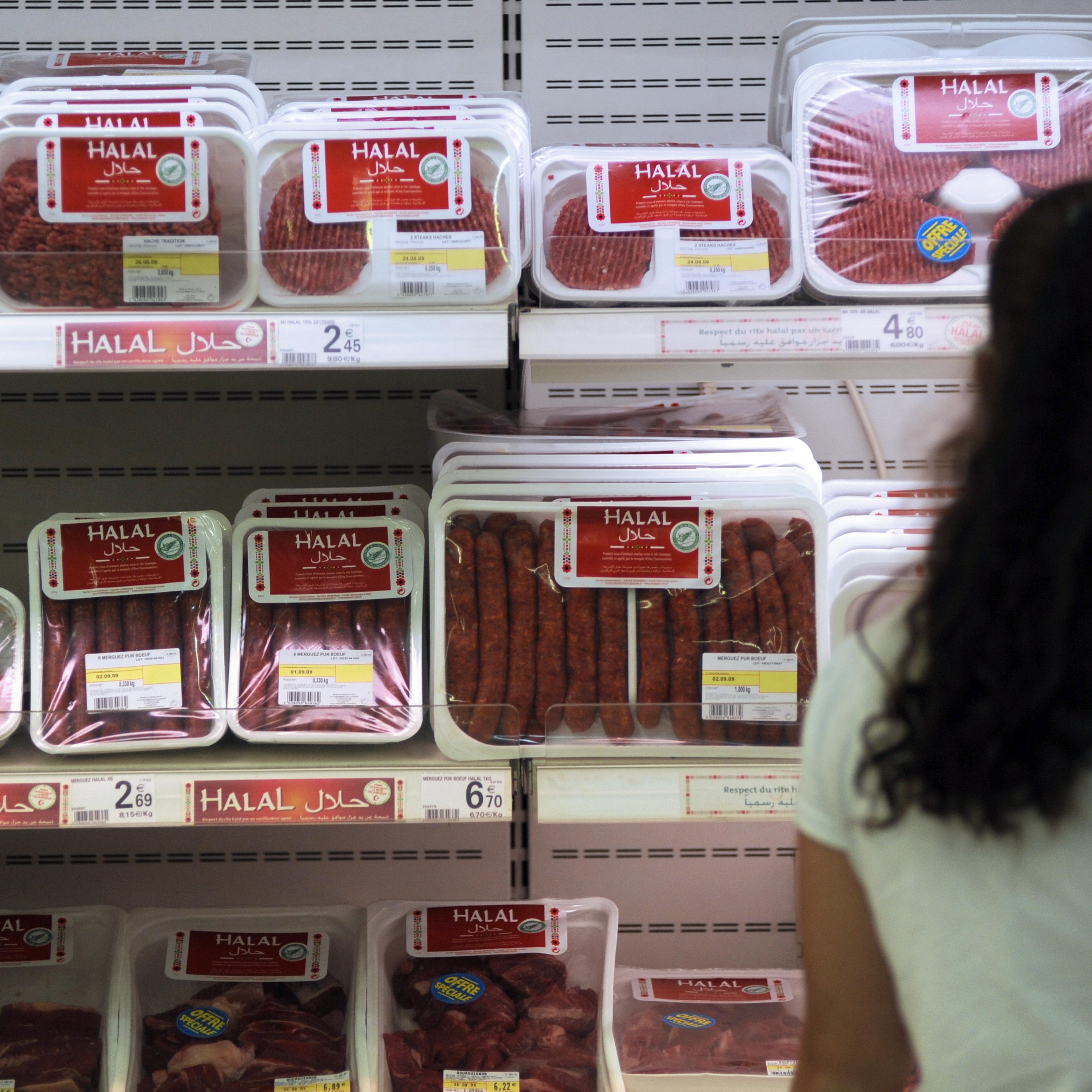 A customer passes by Halal butchery shelves in a supermarket in Illzach, eastern France, on Aug. 21, 2009.