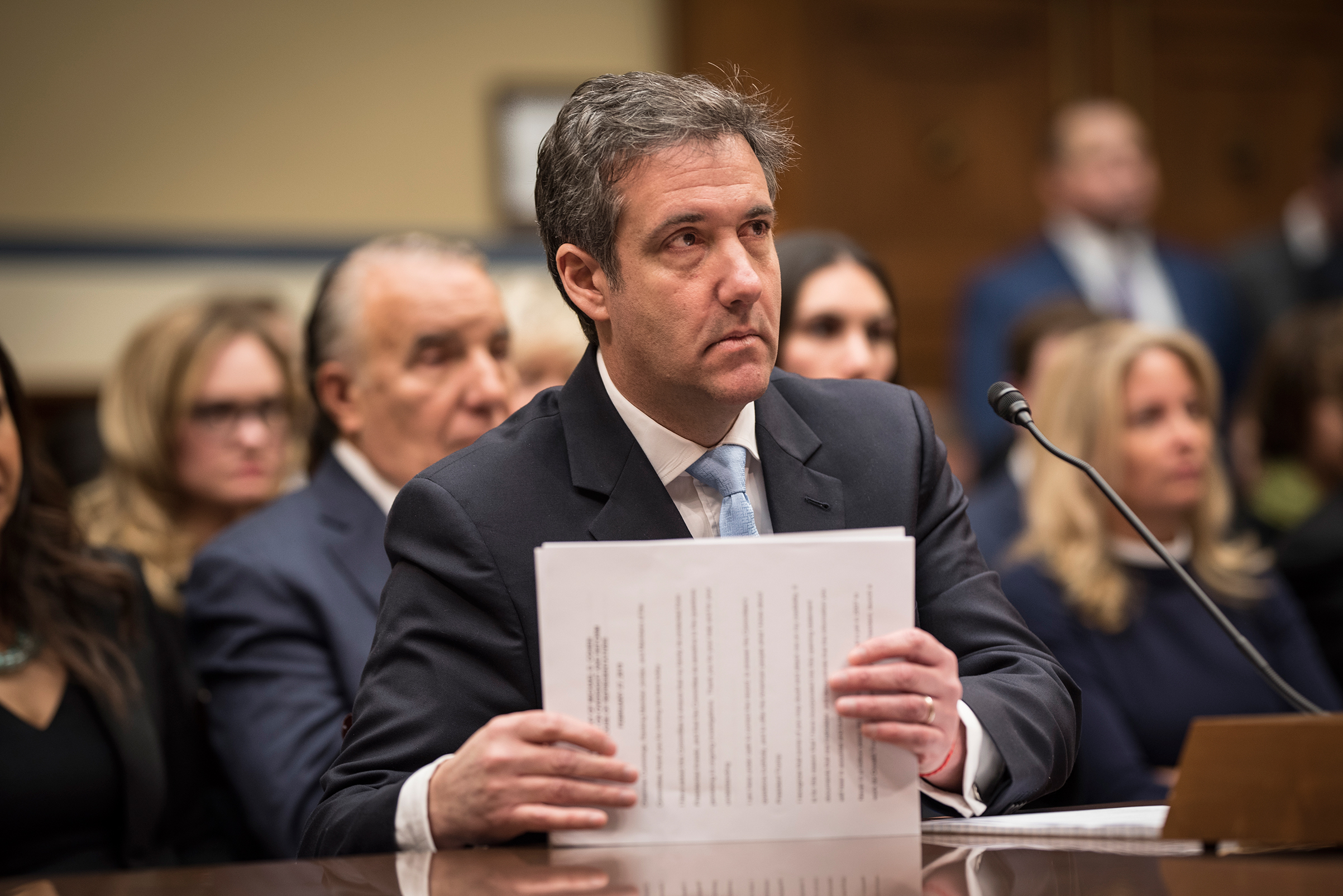 Michael Cohen gathers his papers just after finishing his opening statement before the House Oversight Committee IN Washington, D.C., Feb. 27, 2019.