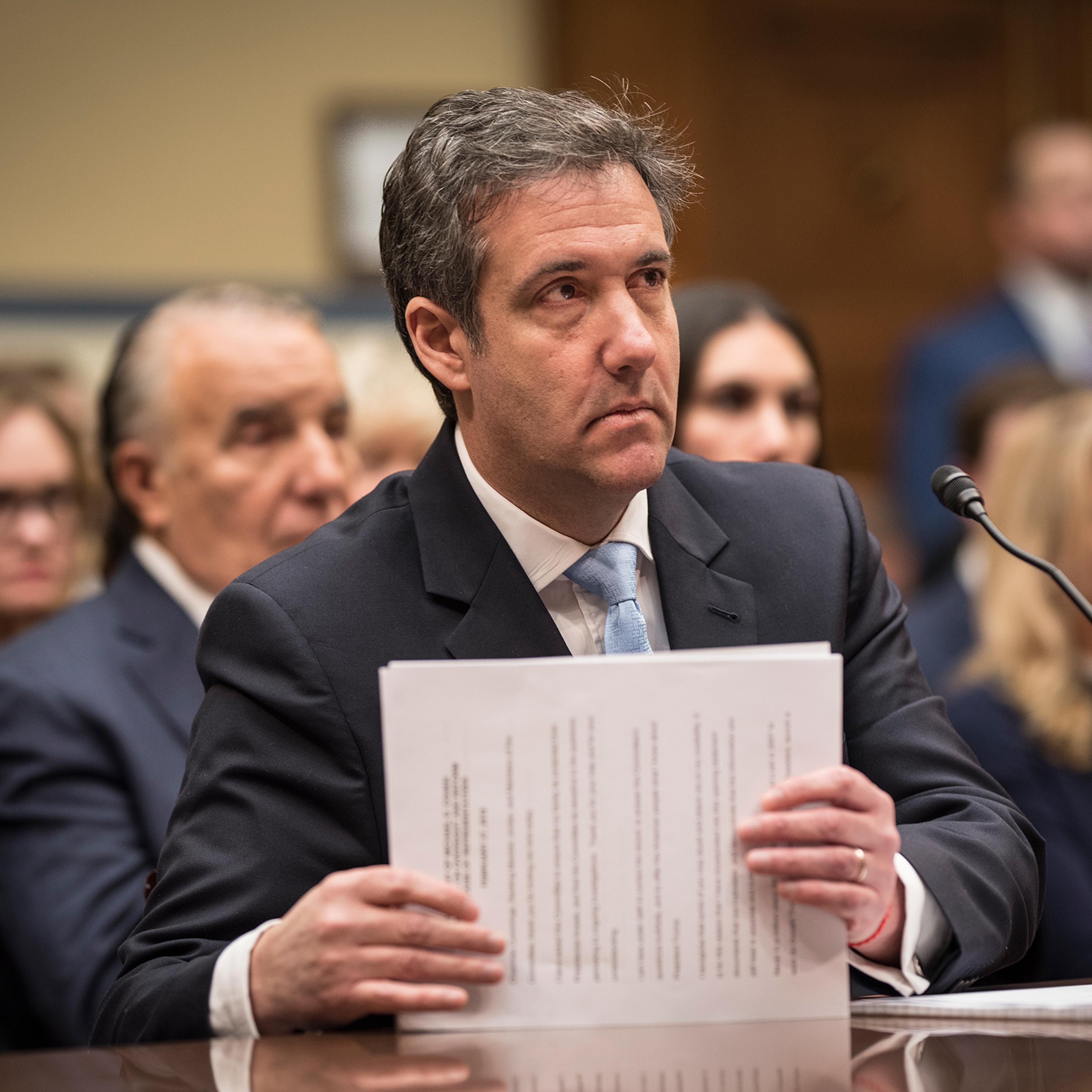 Michael Cohen gathers his papers just after finishing his opening statement before the House Oversight Committee IN Washington, D.C., Feb. 27, 2019.