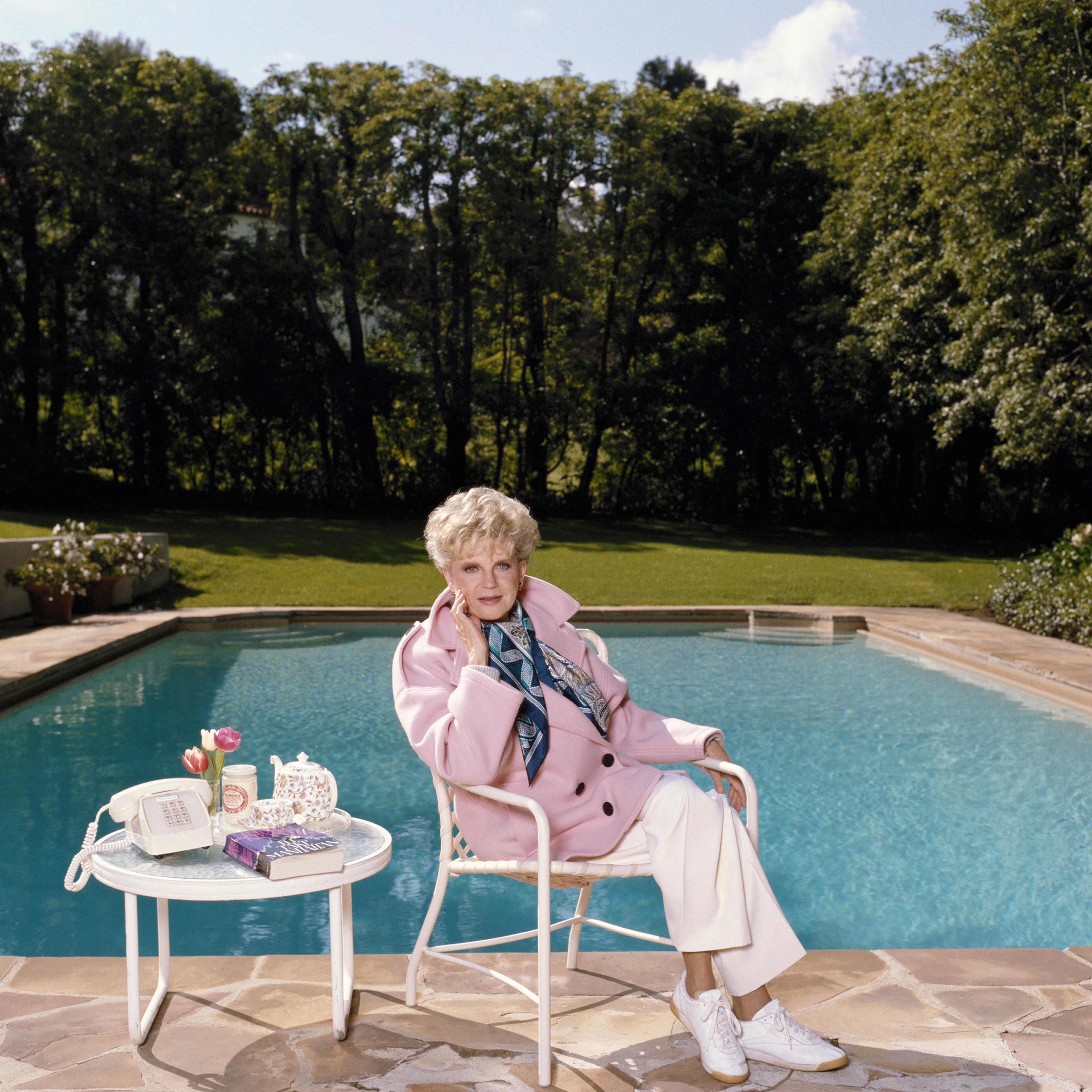 Krantz, seen by her swimming pool in 1986, got her start in journalism before the novel Scruples shifted her career.