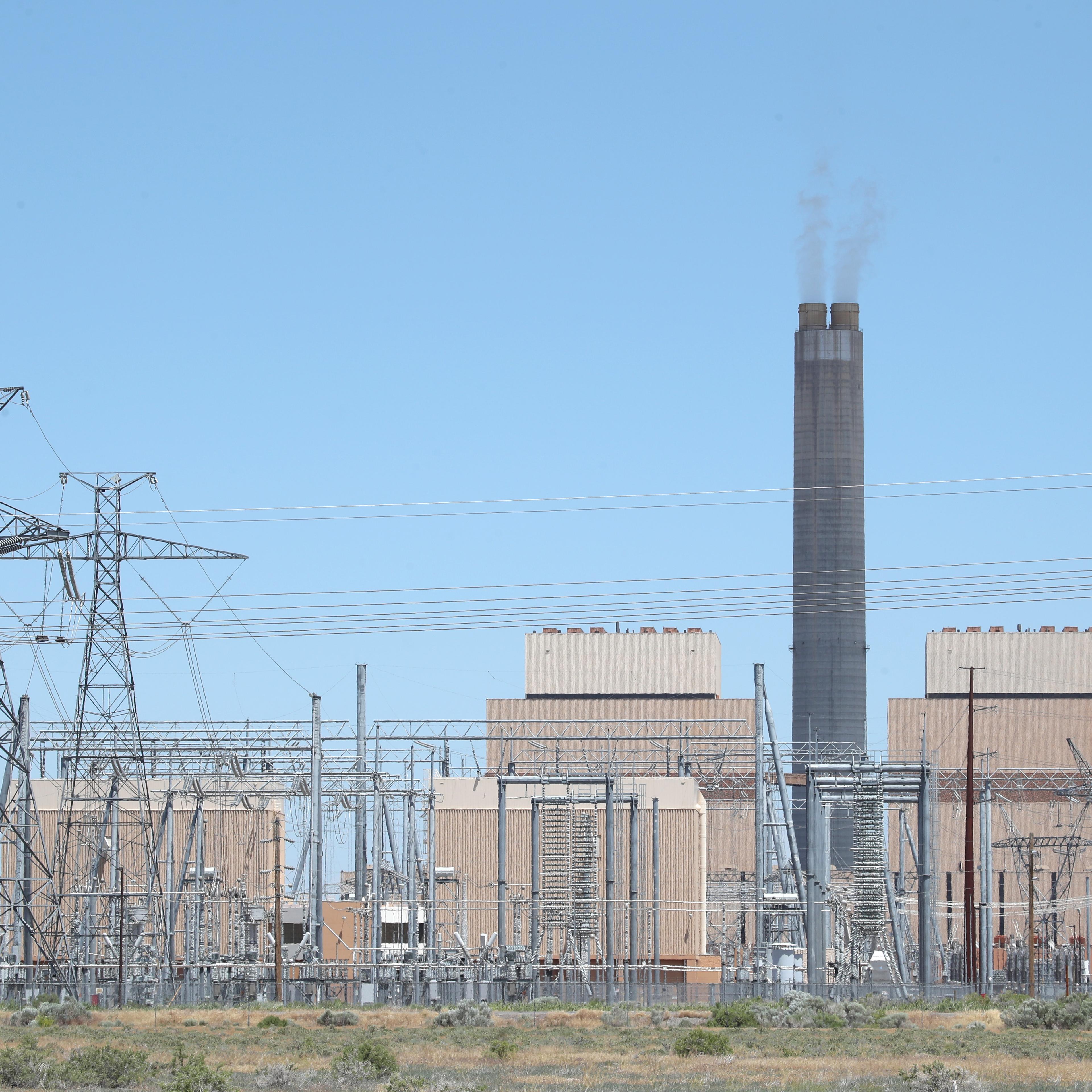 Power lines and a power station stand beside the Intermountain Power Agency coal fired power plant outside Delta, Utah. This plant, like others across the country, is shifting from coal to renewables, which is driving down the energy sector's emissions.