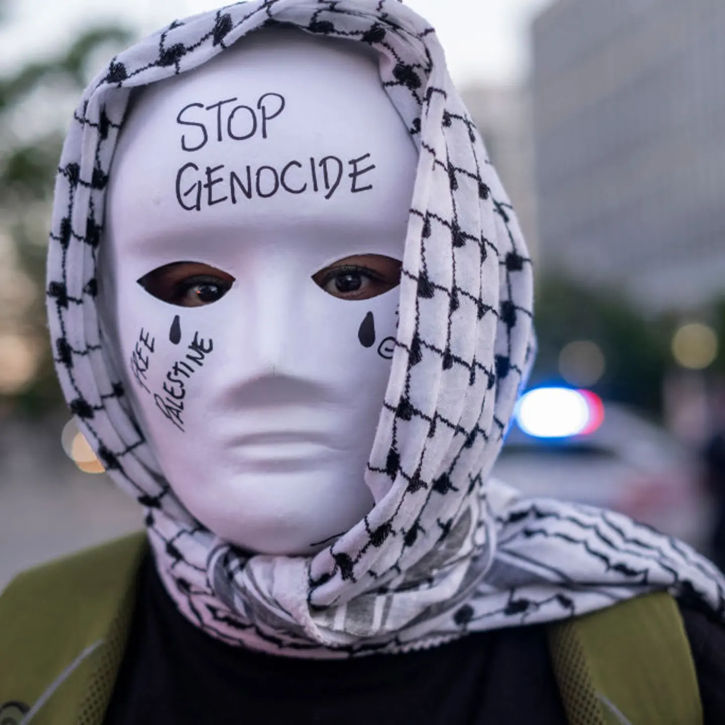 A demonstrator wearing traditional Palestinian Keffiyeh and