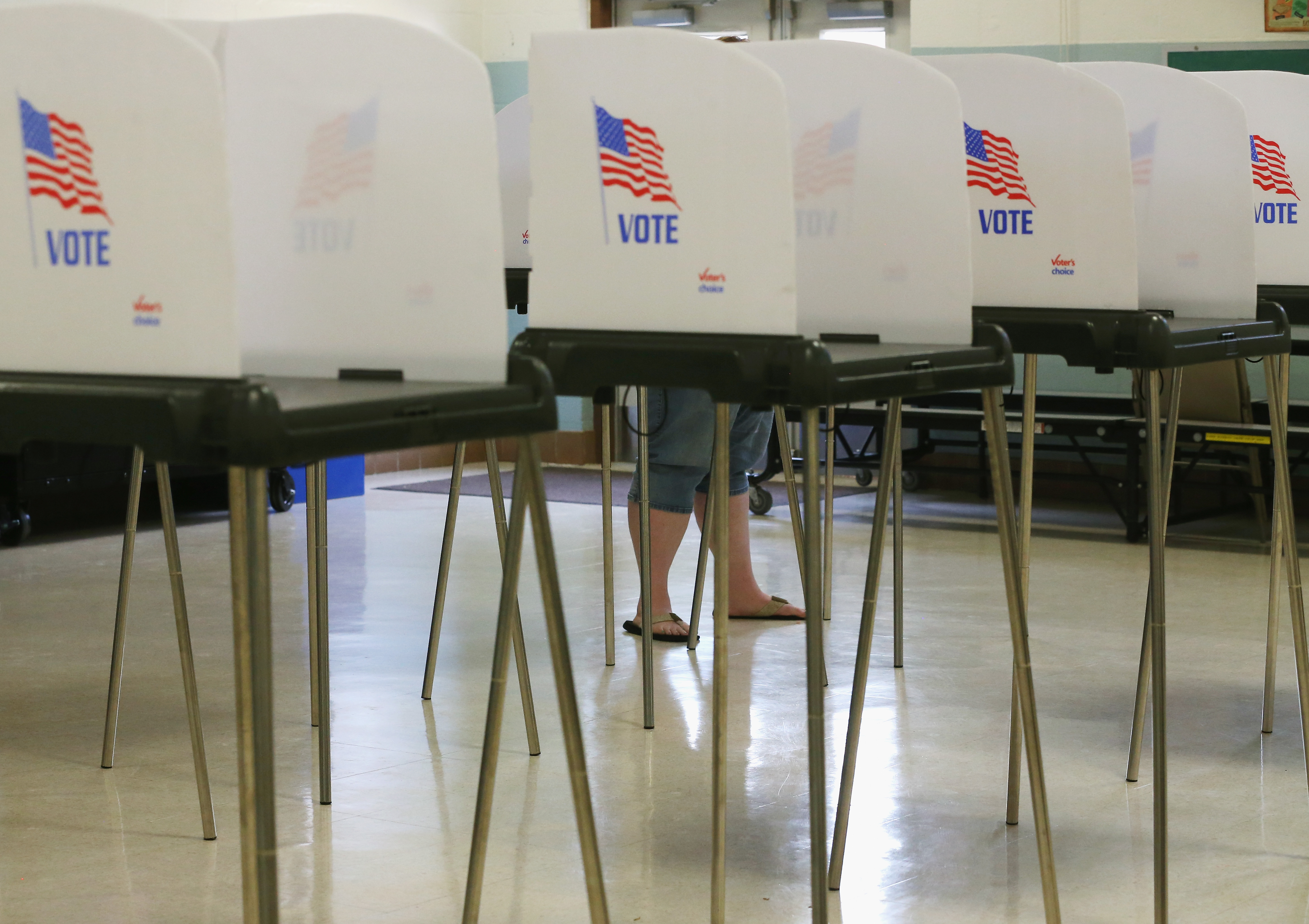 A woman stands at the voting booth at the White Marsh Elementary School polling station in Mechanicsville, Maryland, April 26, 2016.