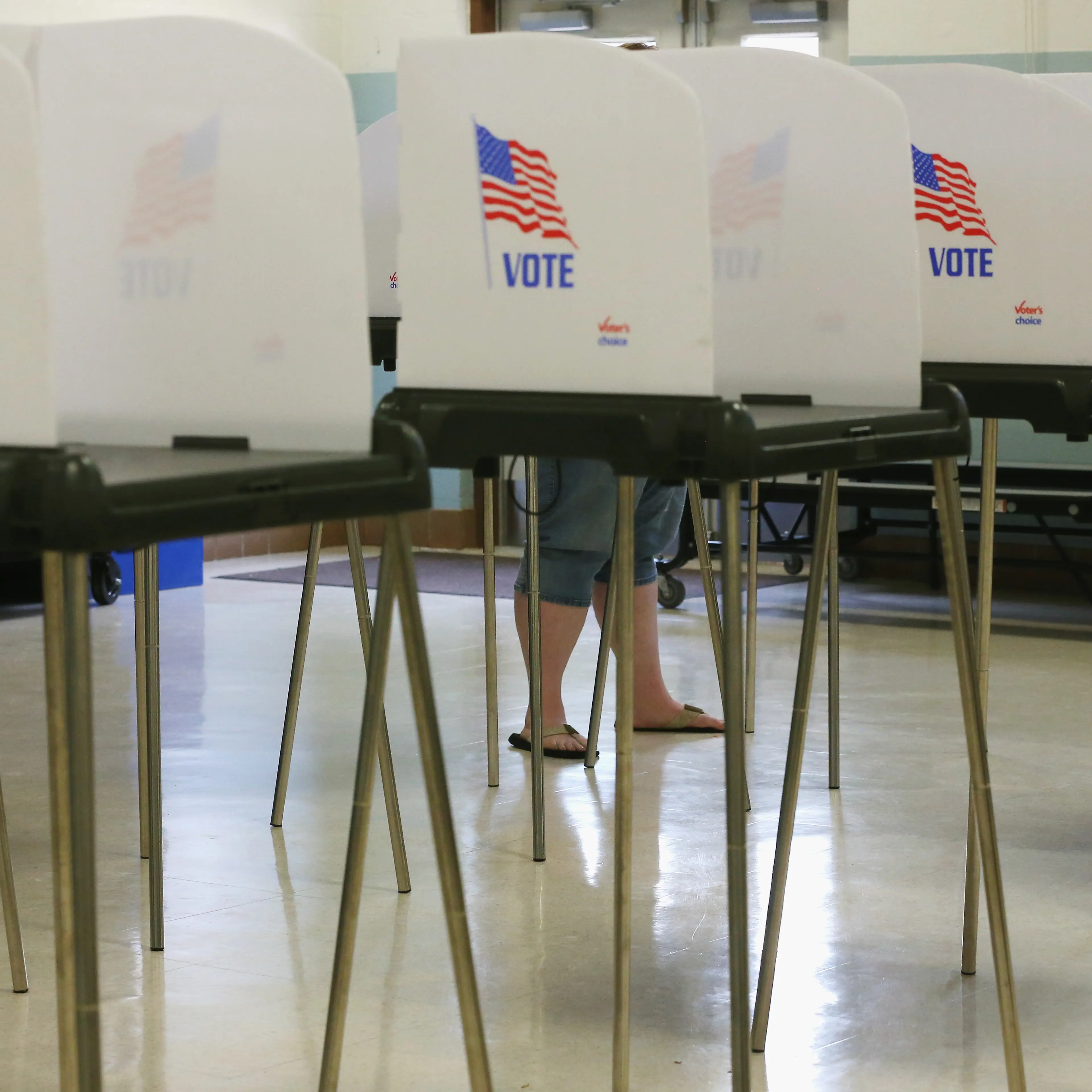 A woman stands at the voting booth at the White Marsh Elementary School polling station in Mechanicsville, Maryland, April 26, 2016.