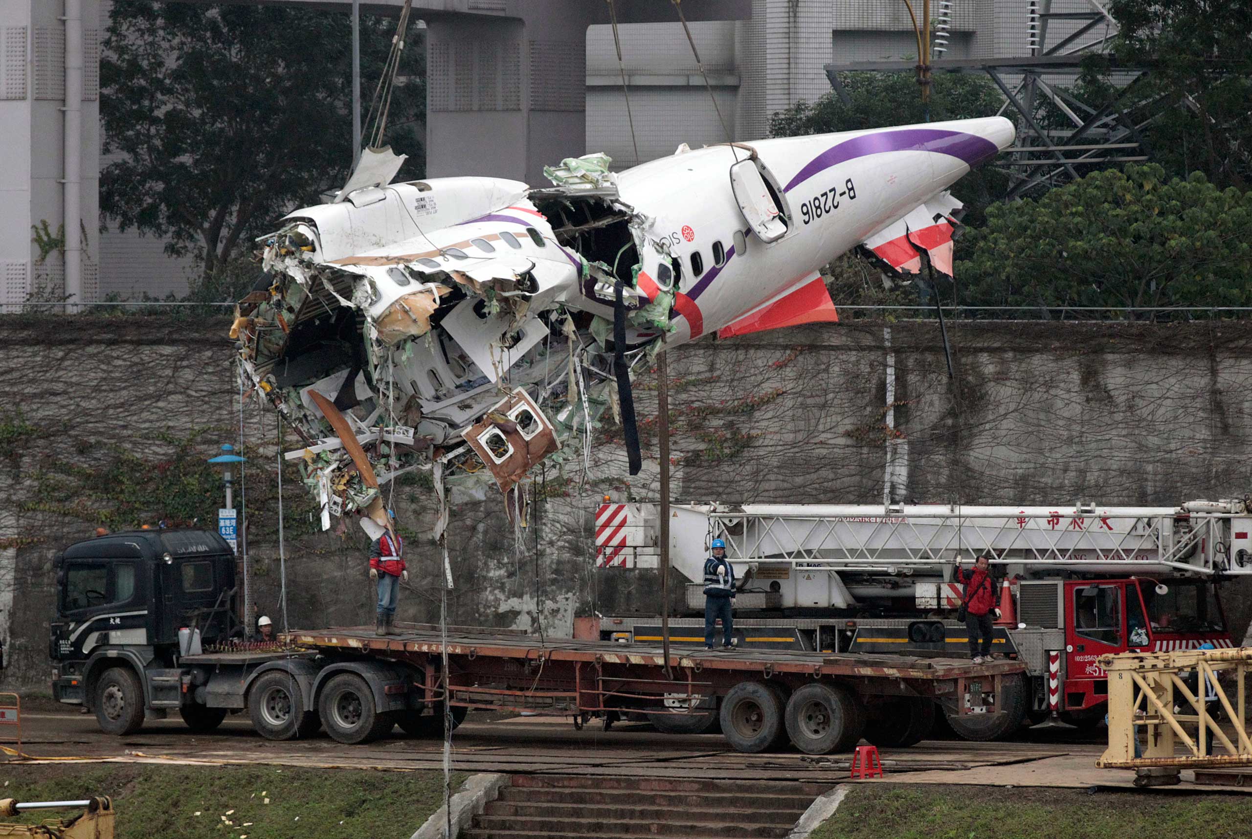 The main fuselage from TransAsia Airways Flight 235 is hoisted away in Taipei, Taiwan, Feb. 5, 2015.