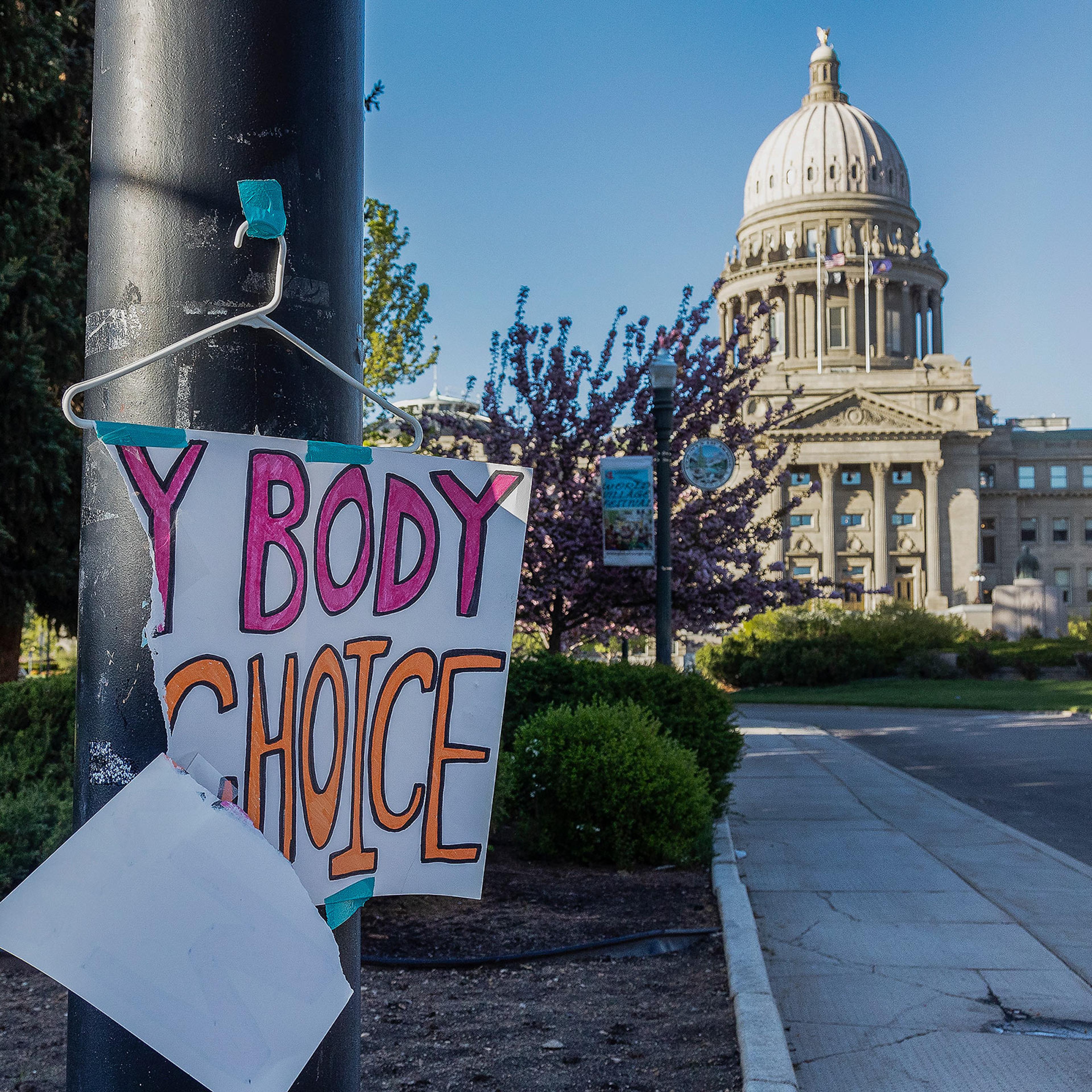 A sign reading "MY BODY MY CHOICE," is taped to a streetlight in front of the Idaho State Capitol in Boise, Idaho, on May 3, 2022.