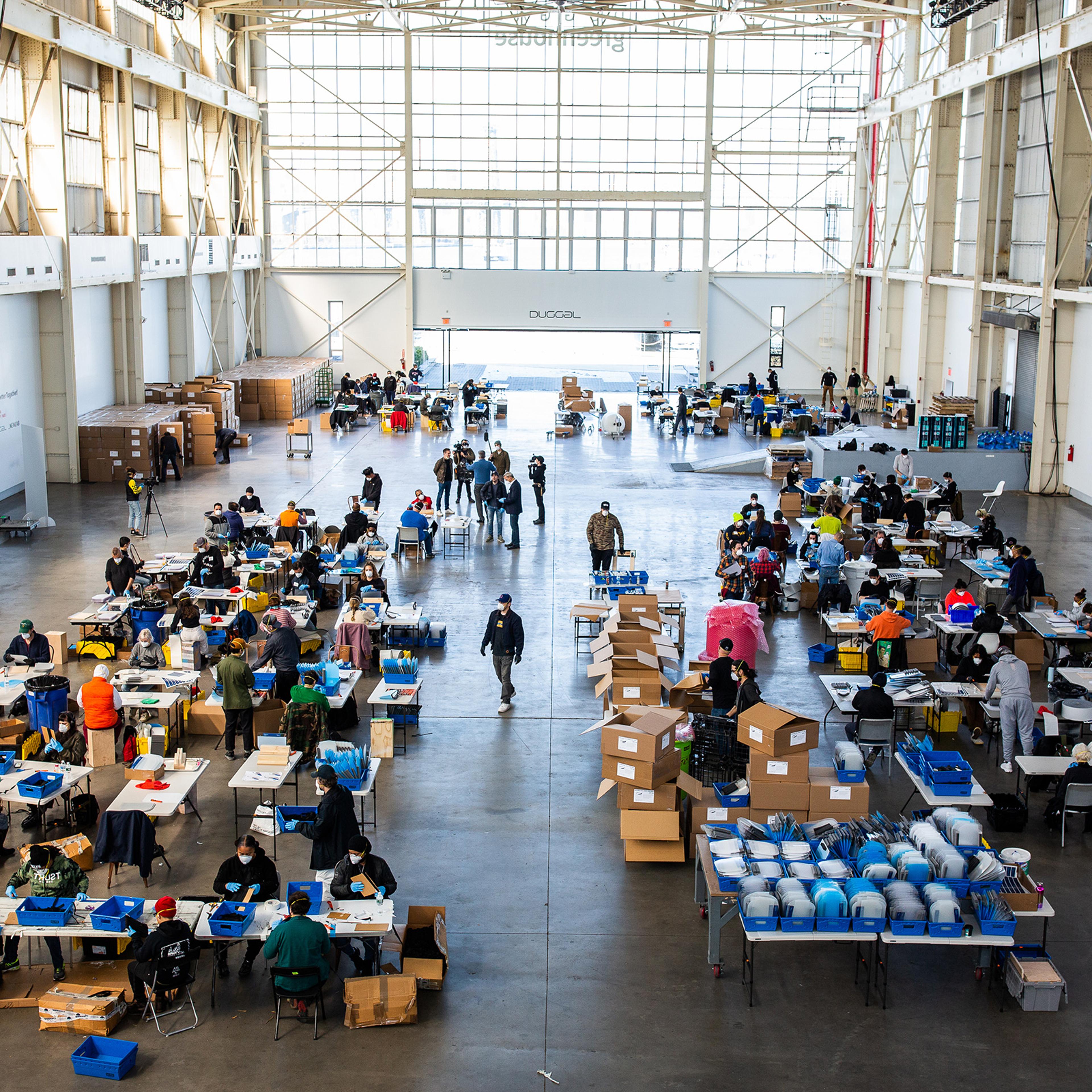 Workers assemble protective masks at Duggal Greenhouse in the Brooklyn, New York, on Thursday, March 26.