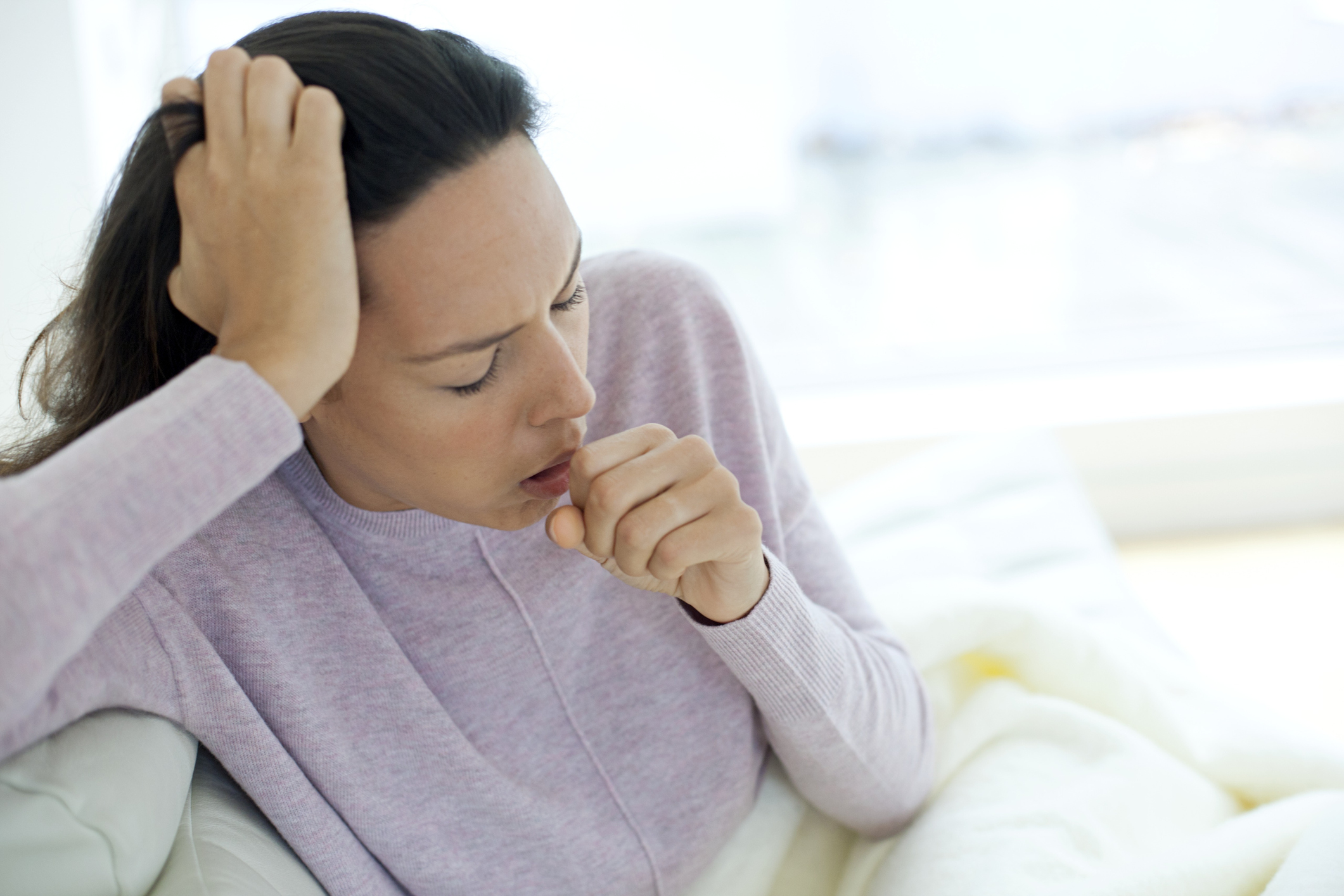 Young woman coughing