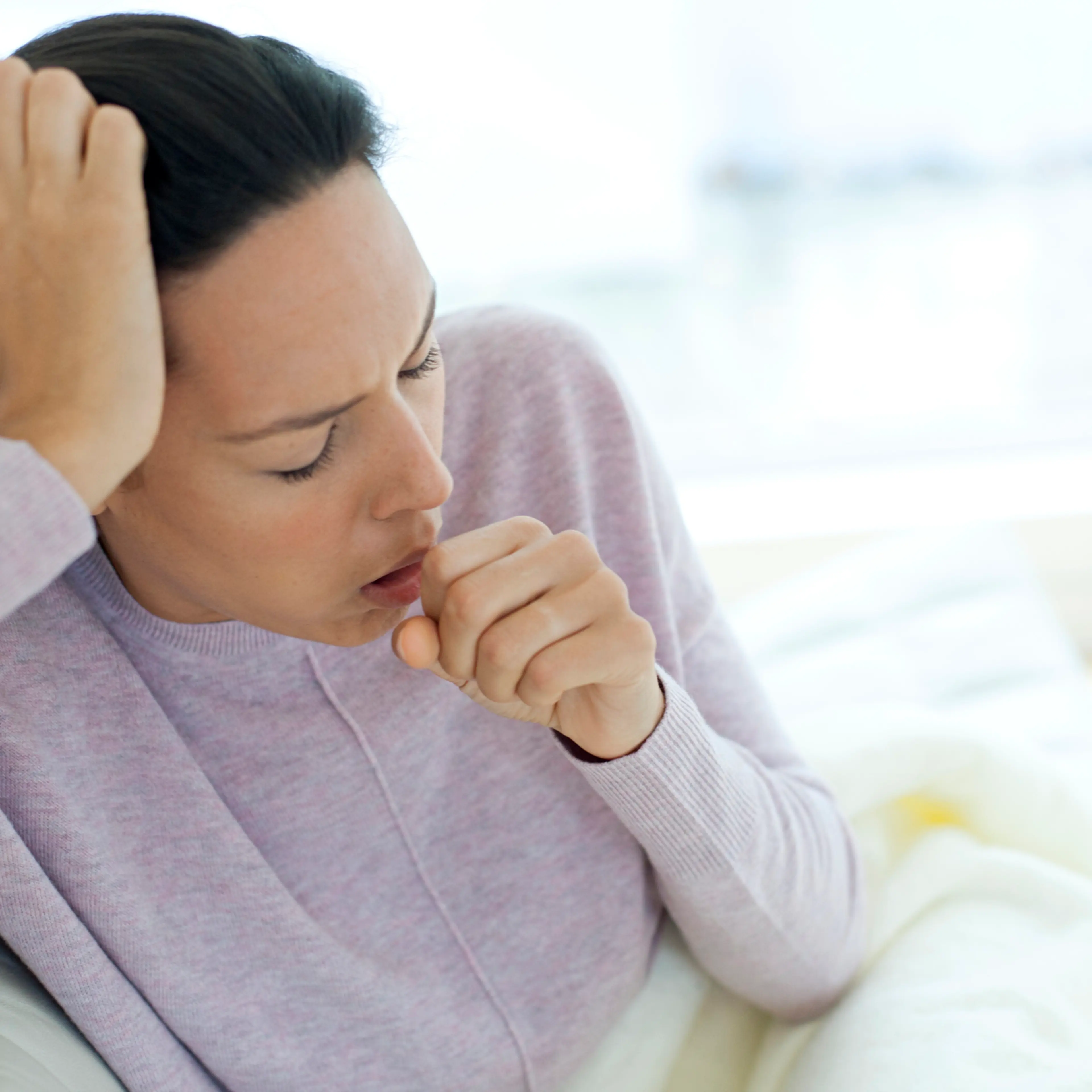 Young woman coughing