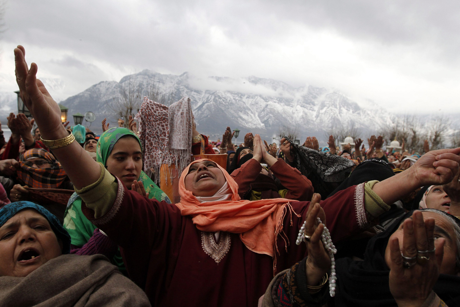 February 5, 2012. Kashmiri Muslim devotees raise their hands for prayers as a head priest displays a relic of Prophet Mohammed at the Hazratbal shrine on the occasion of Eid-e-Milad, or birthday of Prophet Mohammed, in Srinagar, India.