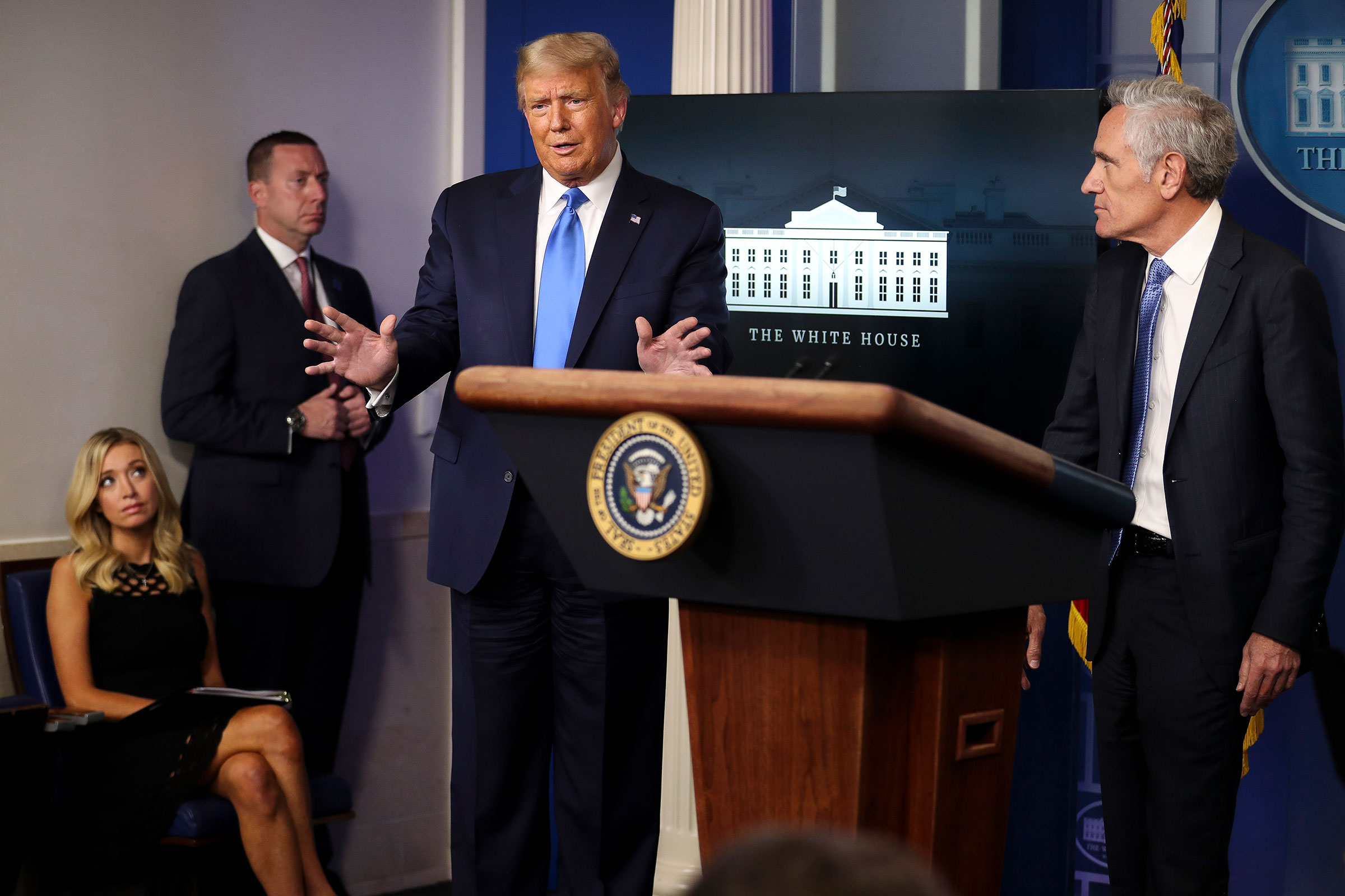President Donald Trump speaks as Dr. Scott Atlas, a White House adviser on the coronavirus, right, and White House Press Secretary Kayleigh McEnany, far left, listen during a press briefing at the White House in Washington, on Wednesday, Sept. 23, 2020. 