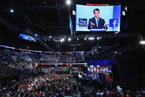 Republican presidential candidate Wisconsin Gov. Scott Walker appears on the large video screen hanging abouve the first prime-time presidential debate hosted by FOX News and Facebook at the Quicken Loans Arena August 6, 2015 in Cleveland, Ohio.