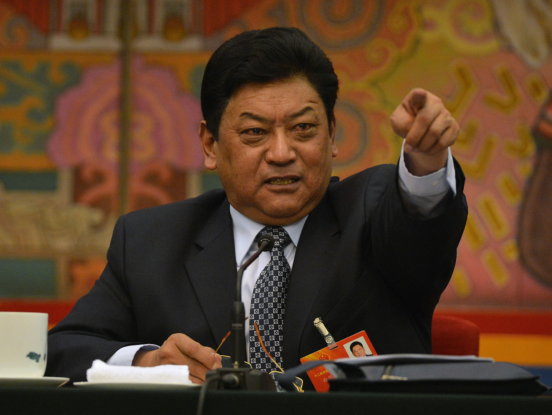 Padma Choling, head of China's Tibet Autonomous Region Congress gestures during their open session in the Great Hall of the people at the National People's Congress in Beijing on March 8, 2013